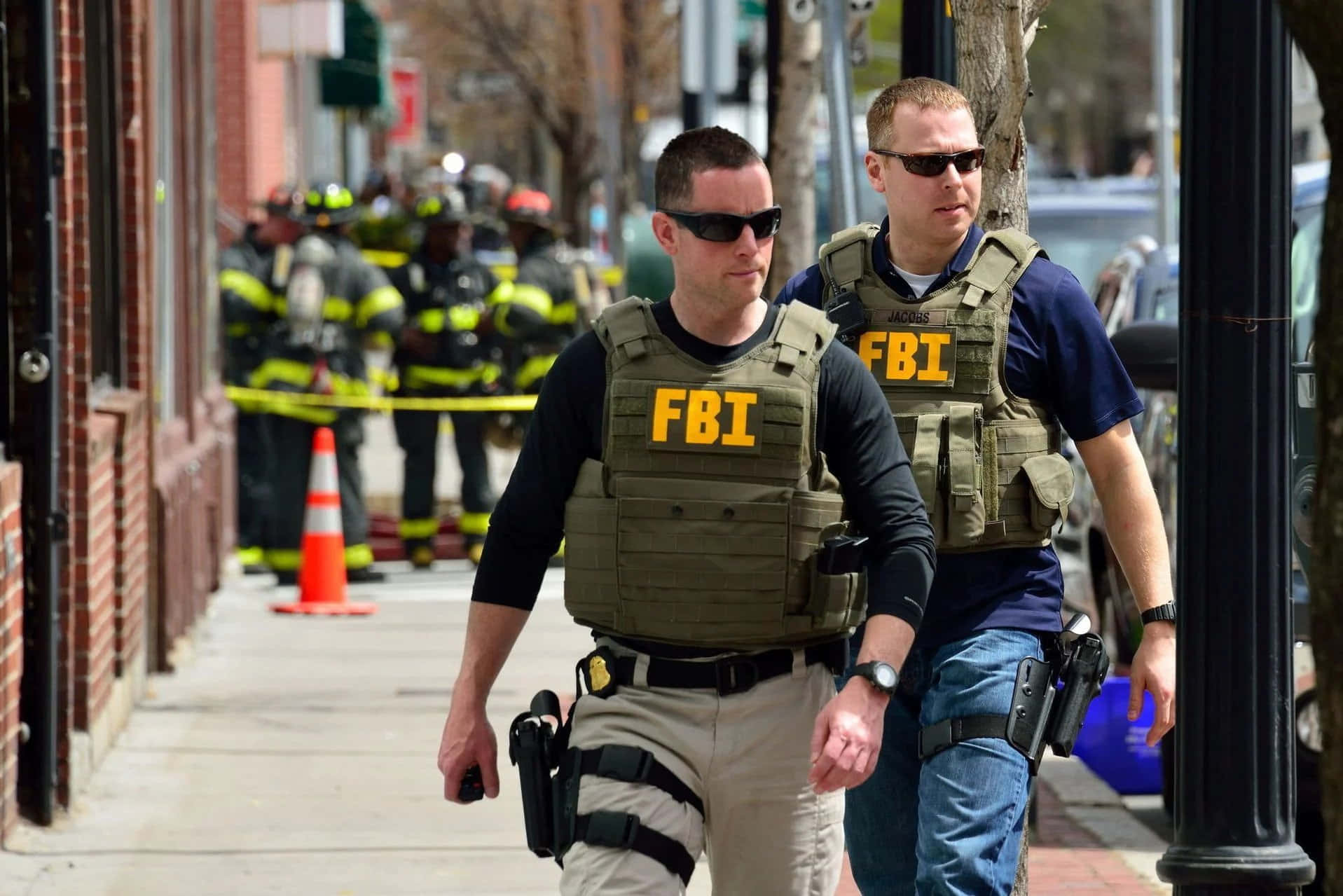 Two Fbi Agents Walking Down A Street
