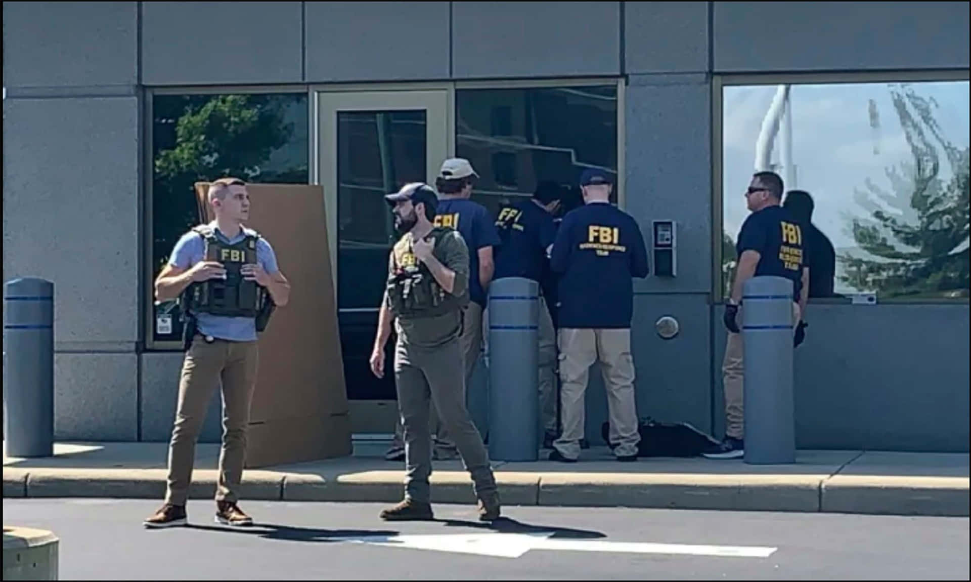 Fbi Agents Stand Outside A Building Wallpaper