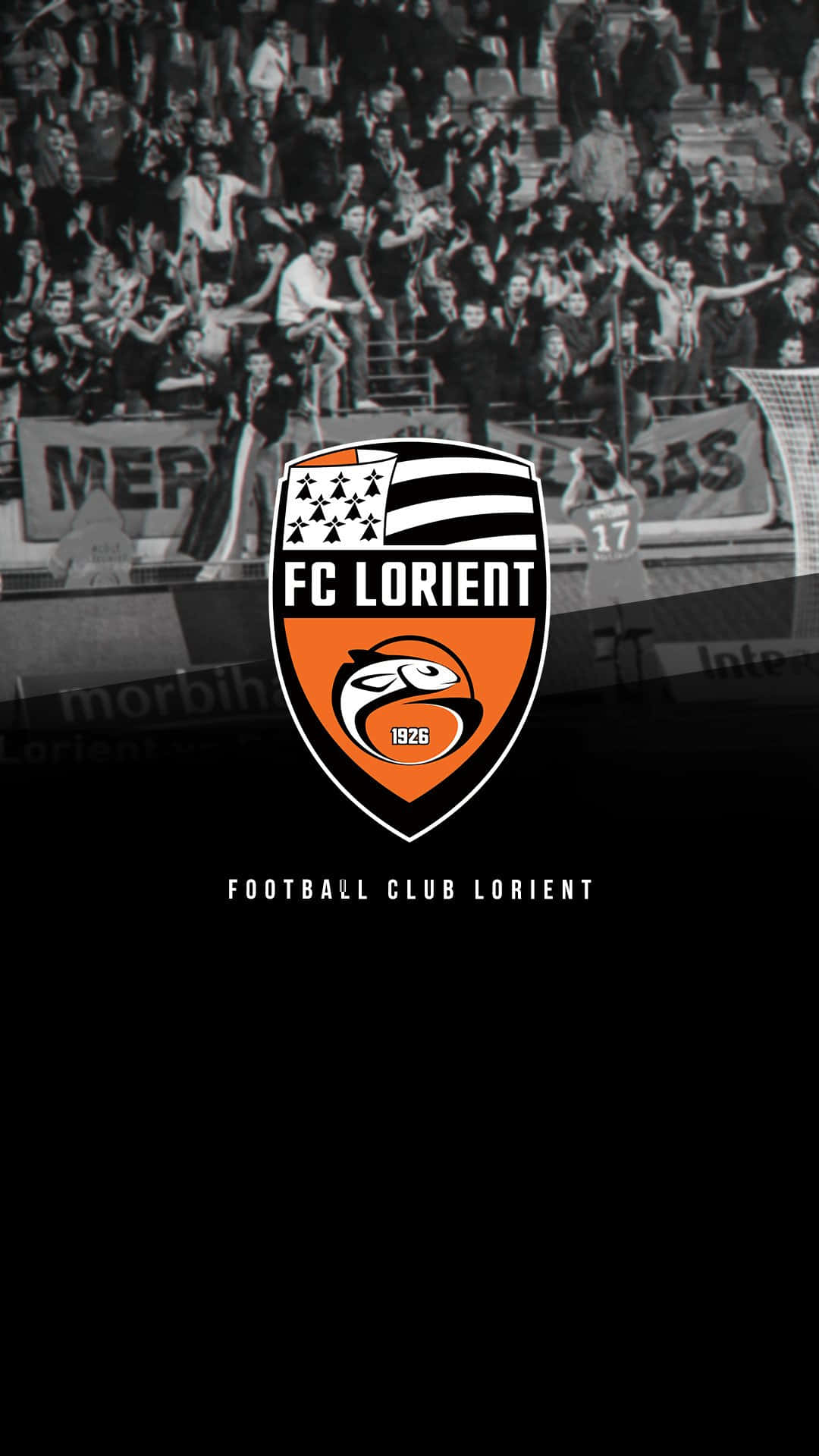 Fc Lorient Players Celebrating Victory On The Pitch Wallpaper