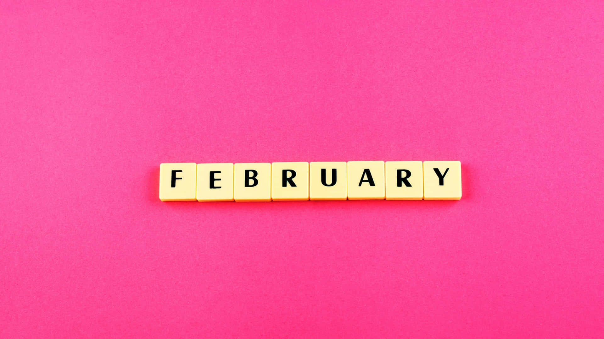 February Spelled Out Tiles Pink Background Wallpaper
