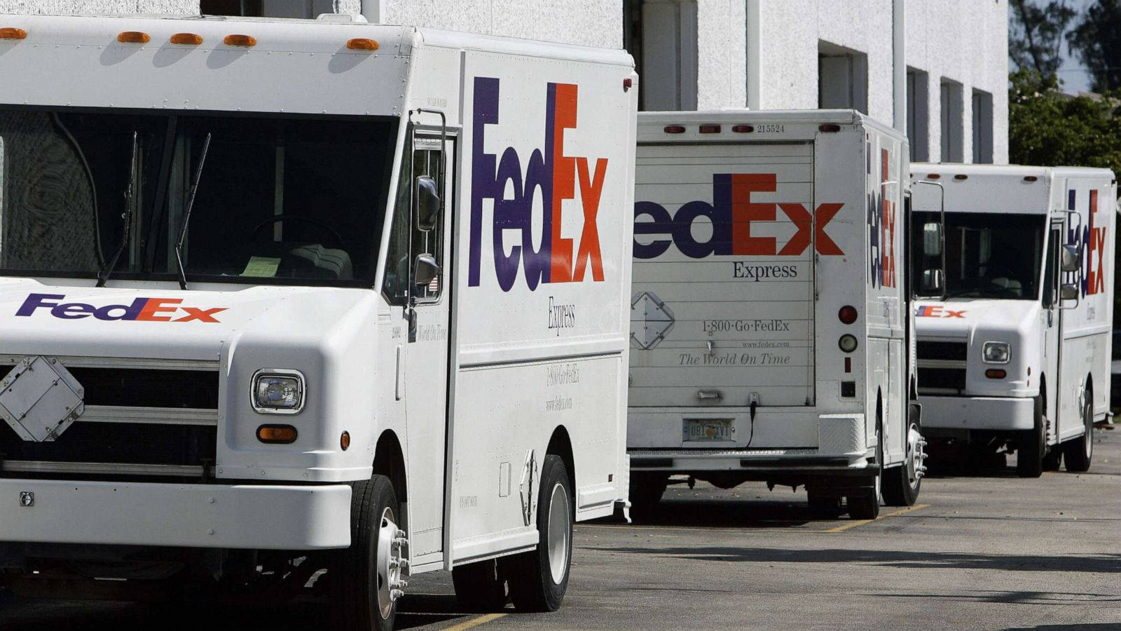 FedEx Tracking Vehicles Parked Wallpaper