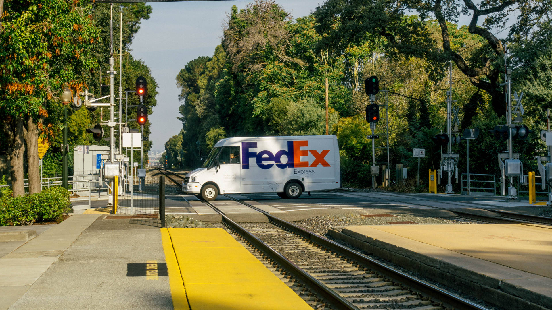 FedEx Van At Railway Crossing Wallpaper