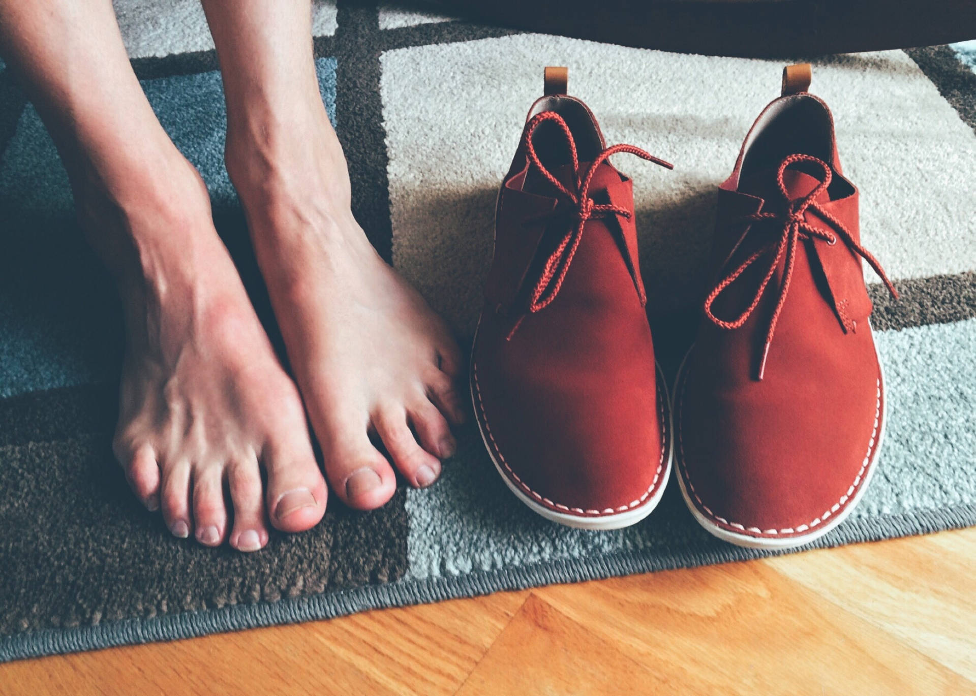 Feet Beside Red Suede Shoes Wallpaper