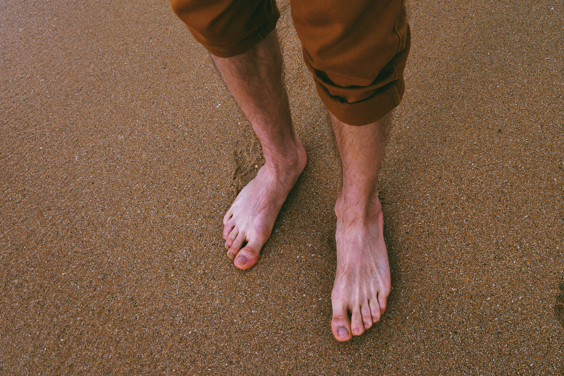 Feet On Brown Sand Beach Background