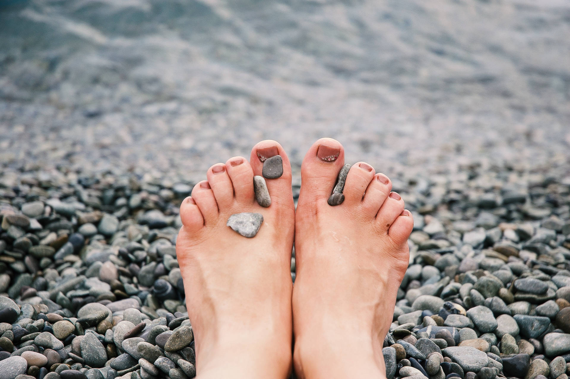 Feet On The Beach With Pebbles Wallpaper