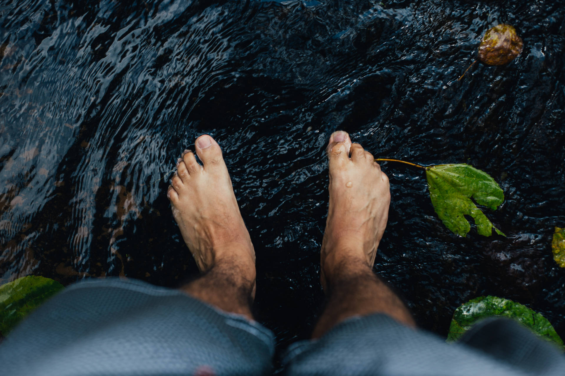 Feet Submerged In A Dark Water Wallpaper