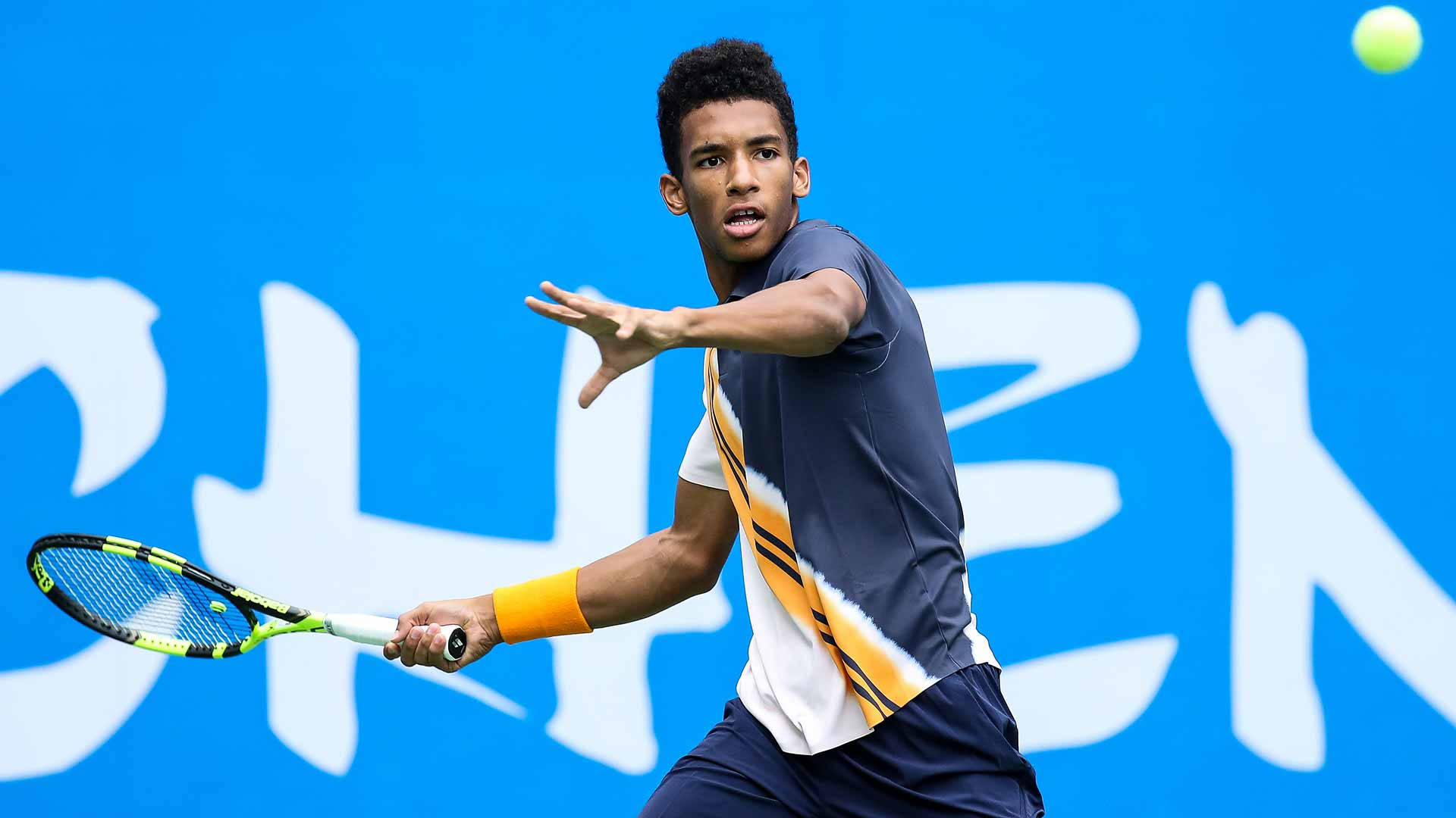 Felix Auger-Aliassime Concentrating on the Ball in Tennis match Wallpaper
