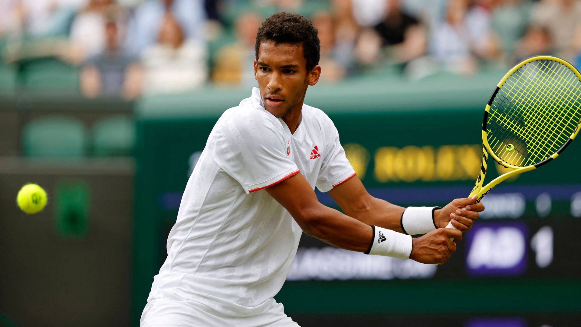 Felix Auger-Aliassime in action with his tennis racket Wallpaper