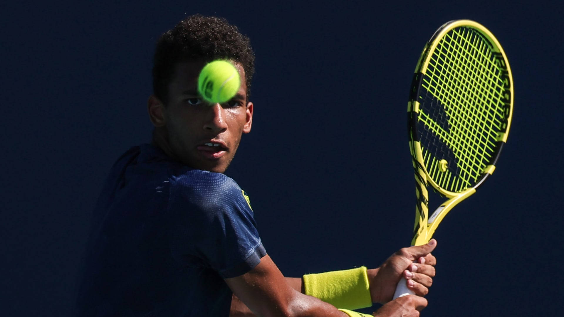 Felix Auger-Aliassime showcasing a steady, focused expression during a game. Wallpaper