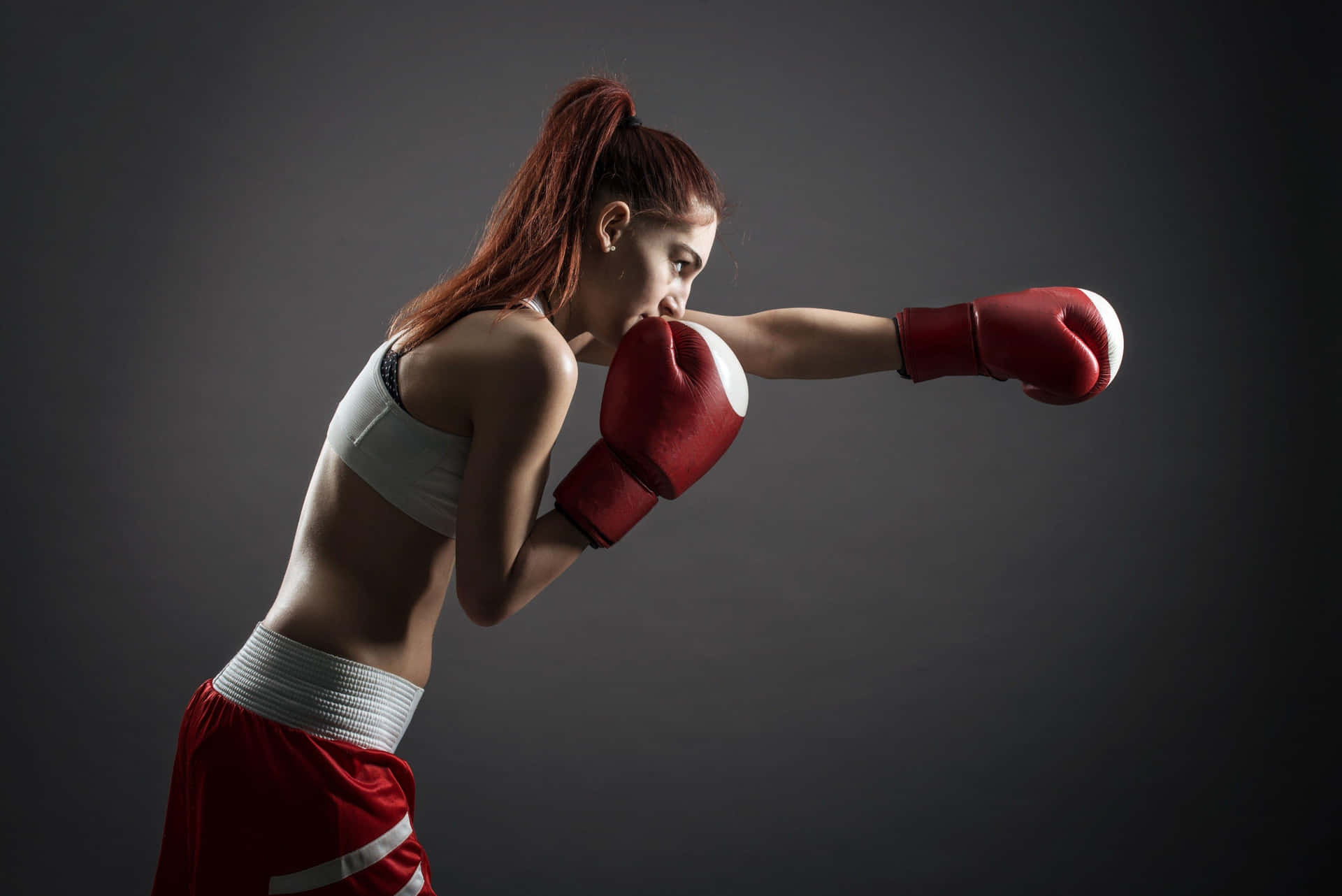 Female Boxer Throwing Punch Wallpaper
