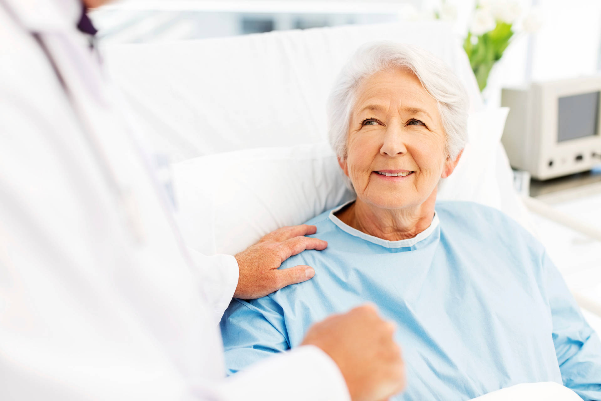 Elderly Female Patient Relaxing in Hospital Bed Wallpaper
