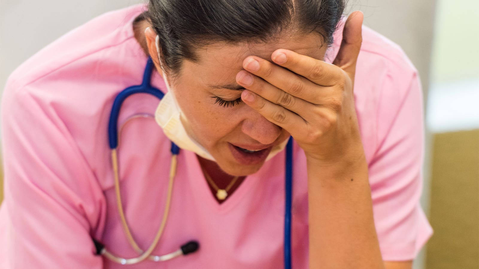 Caption: Stressed Female Nurse Fighting Headache Wallpaper