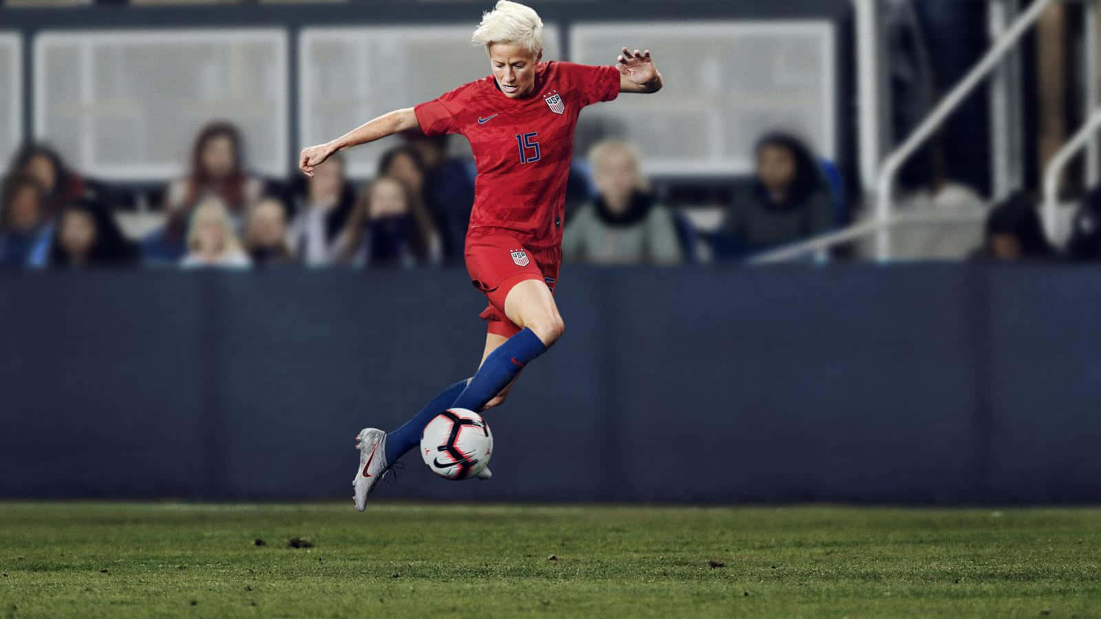 Female Soccer Player Mid Kick Wallpaper