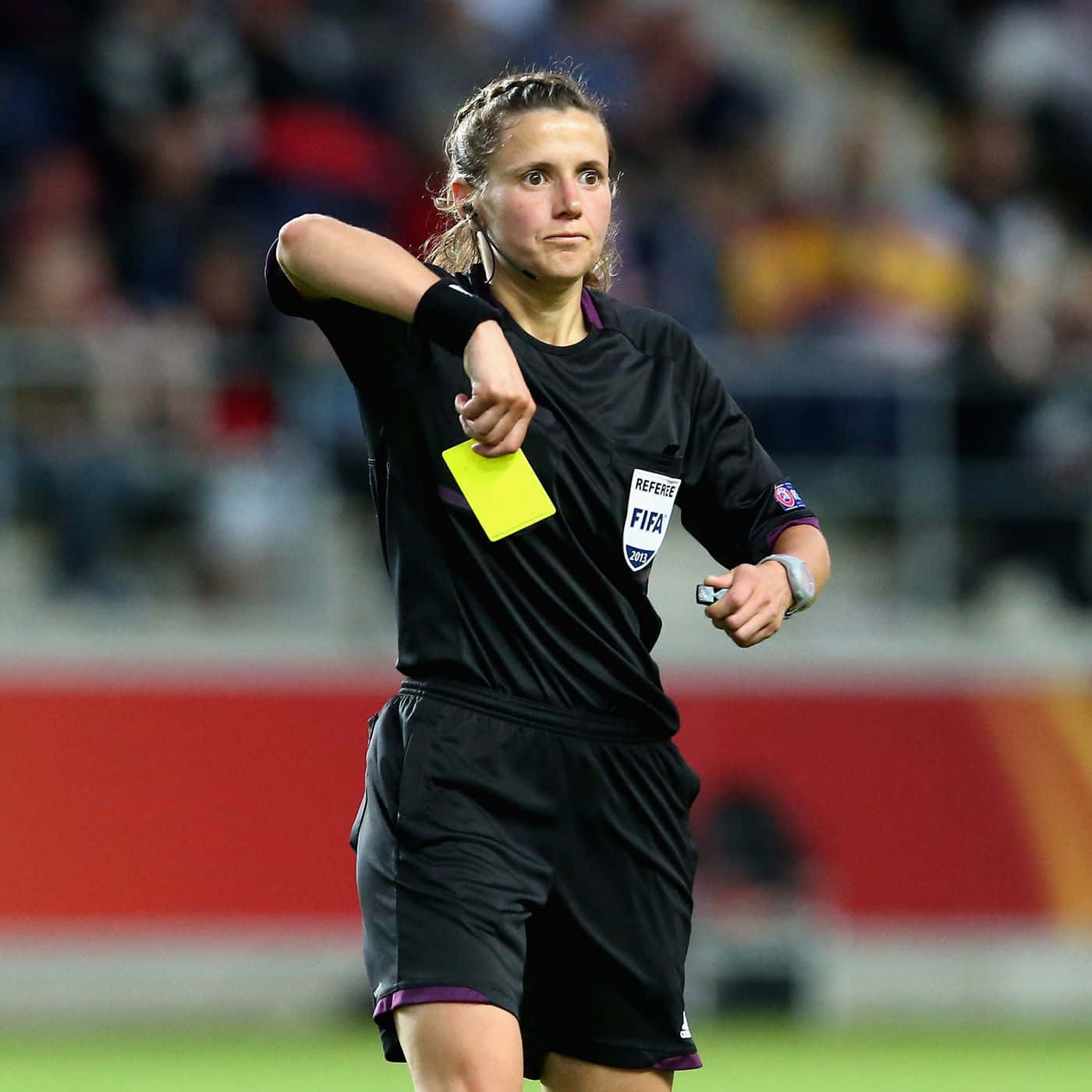 Female Soccer Referee Issuing Yellow Card Wallpaper