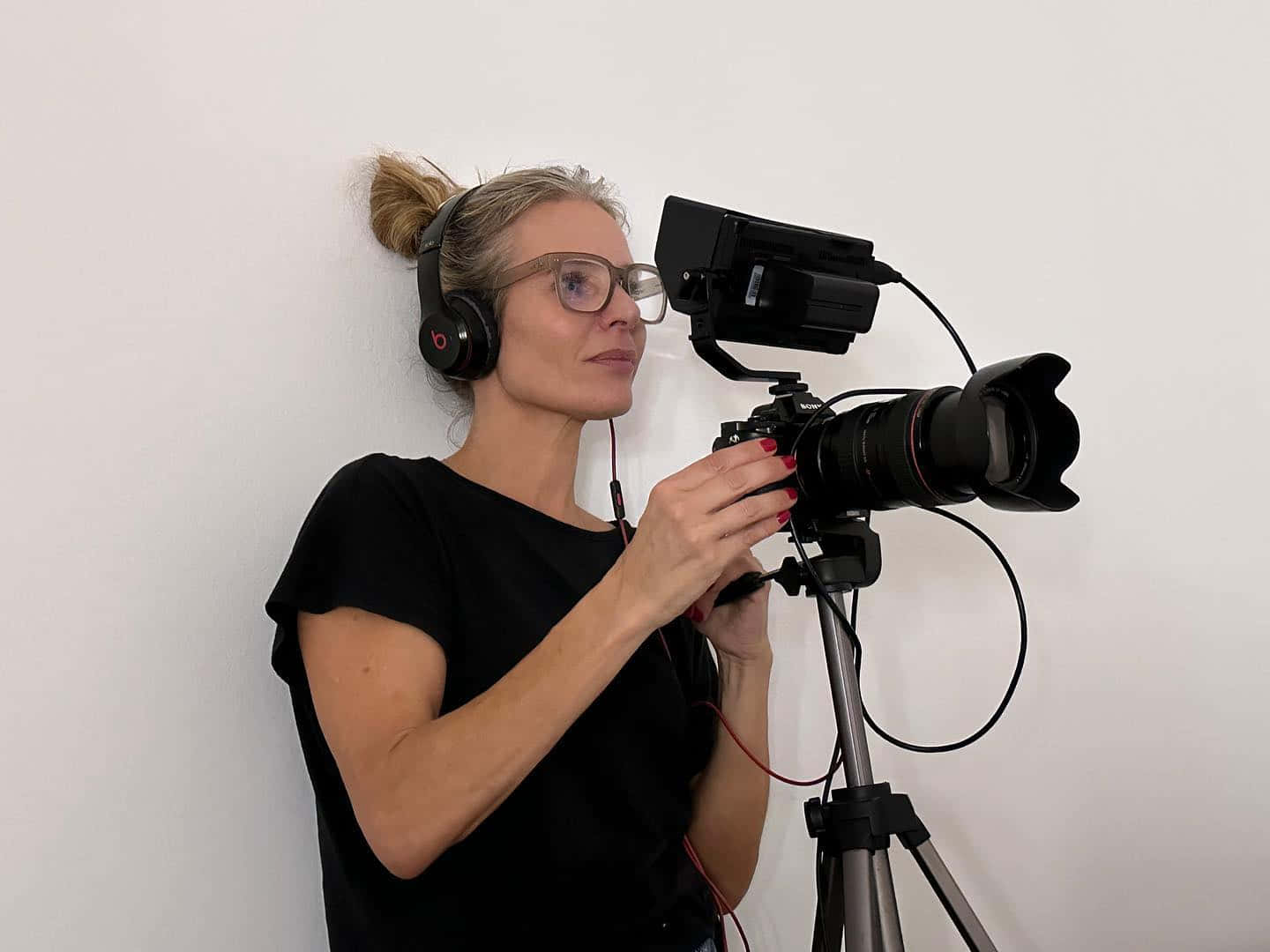 Female Videographer Operating Camera Wallpaper