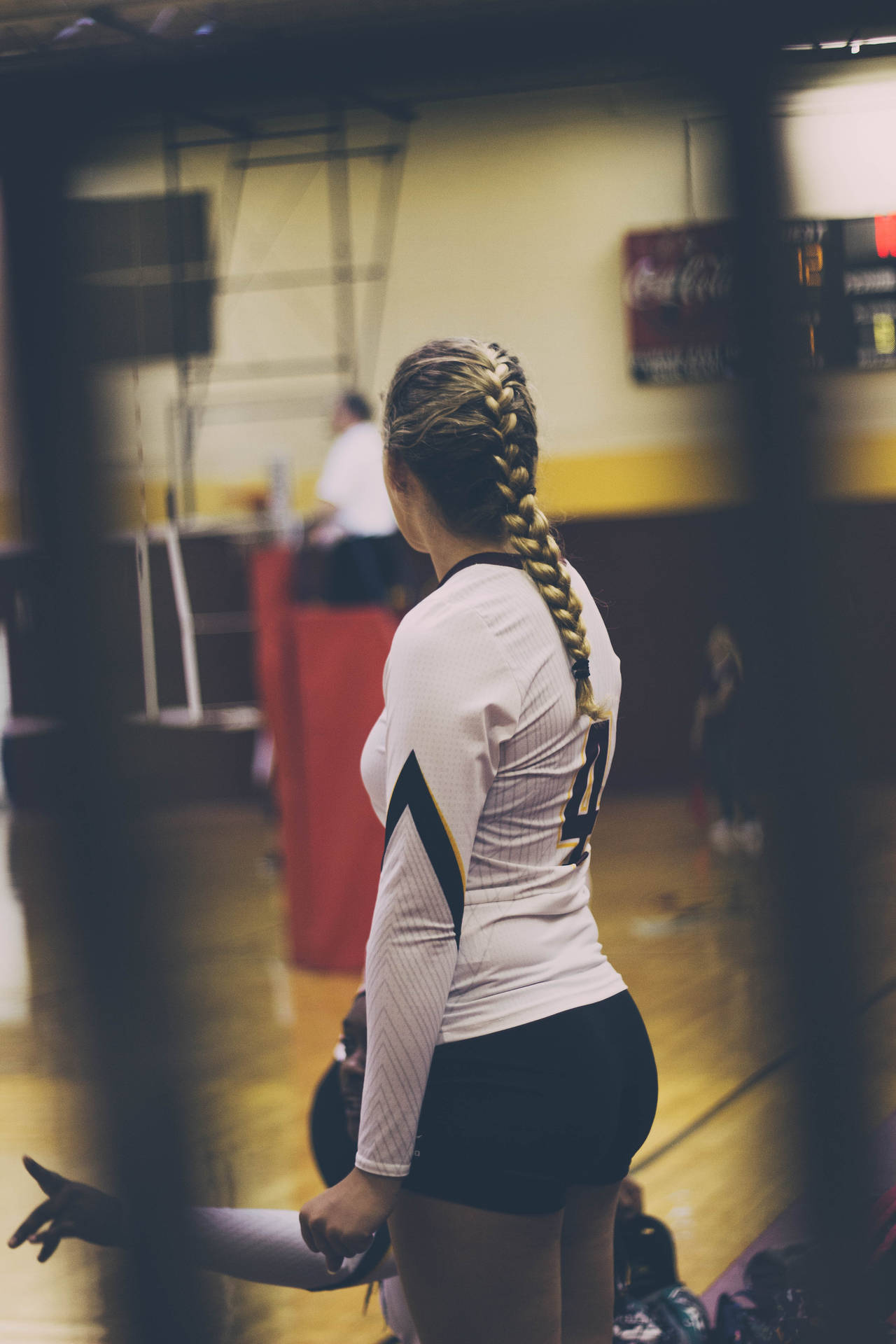 Female Volleyball Player On Court Wallpaper