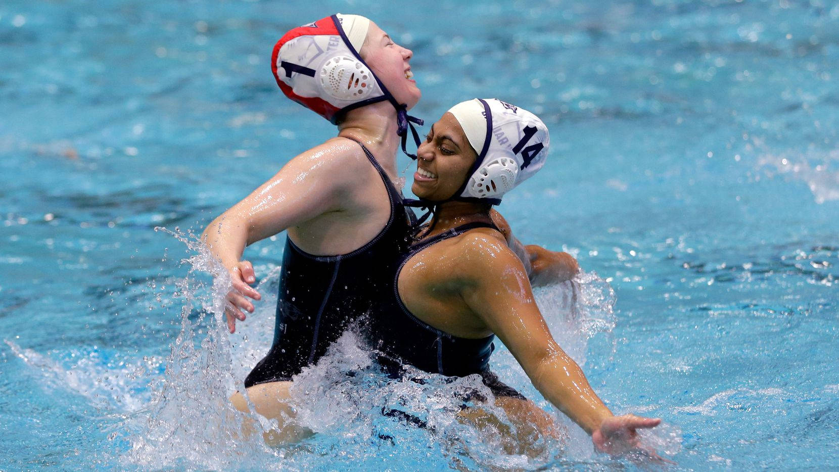 Female Water Polo Athletes Chest Bumping Wallpaper