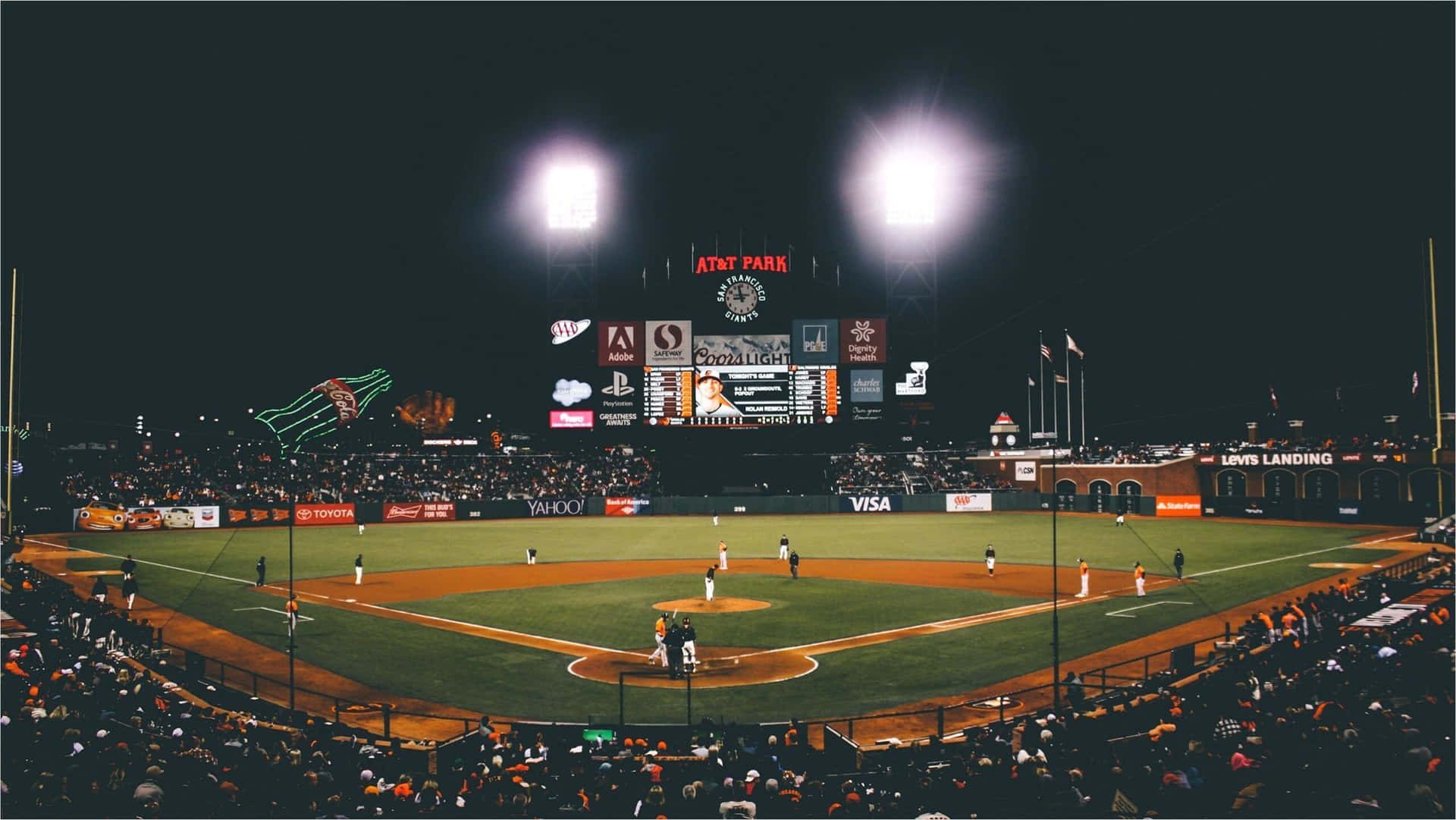 A Baseball Field With Lights Wallpaper