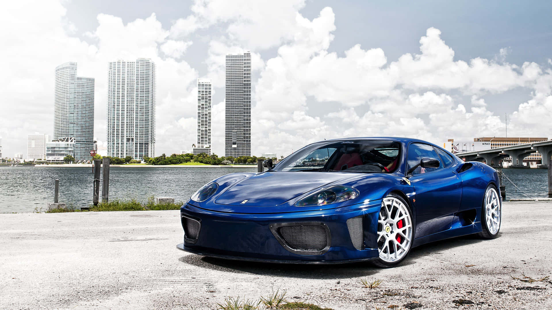 A Stunning Red Ferrari 360 Modena Parked Against a Scenic Backdrop Wallpaper