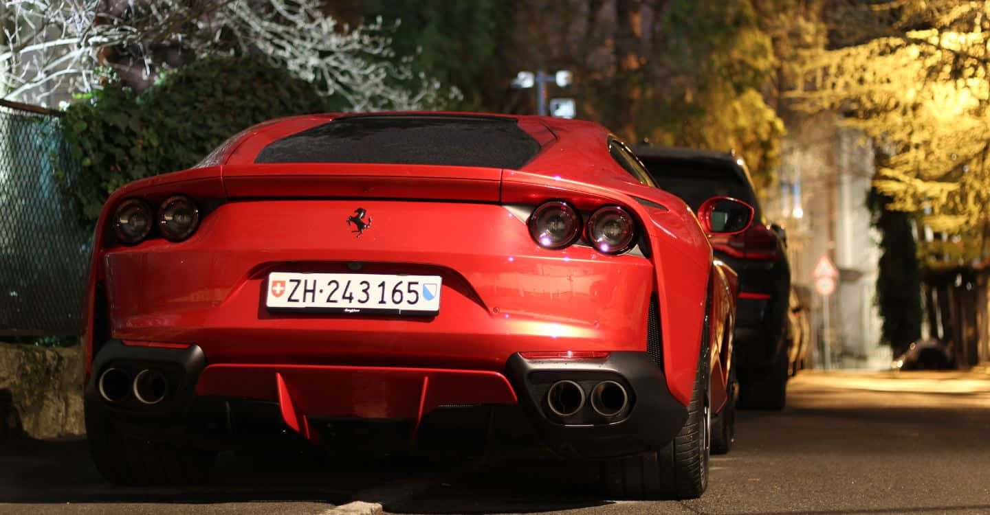 The Majestic Red Ferrari 812 Superfast on the Road Wallpaper