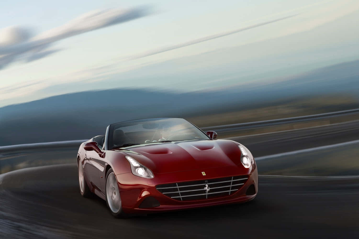 Stunning Red Ferrari California T Cruising On Open Road Wallpaper