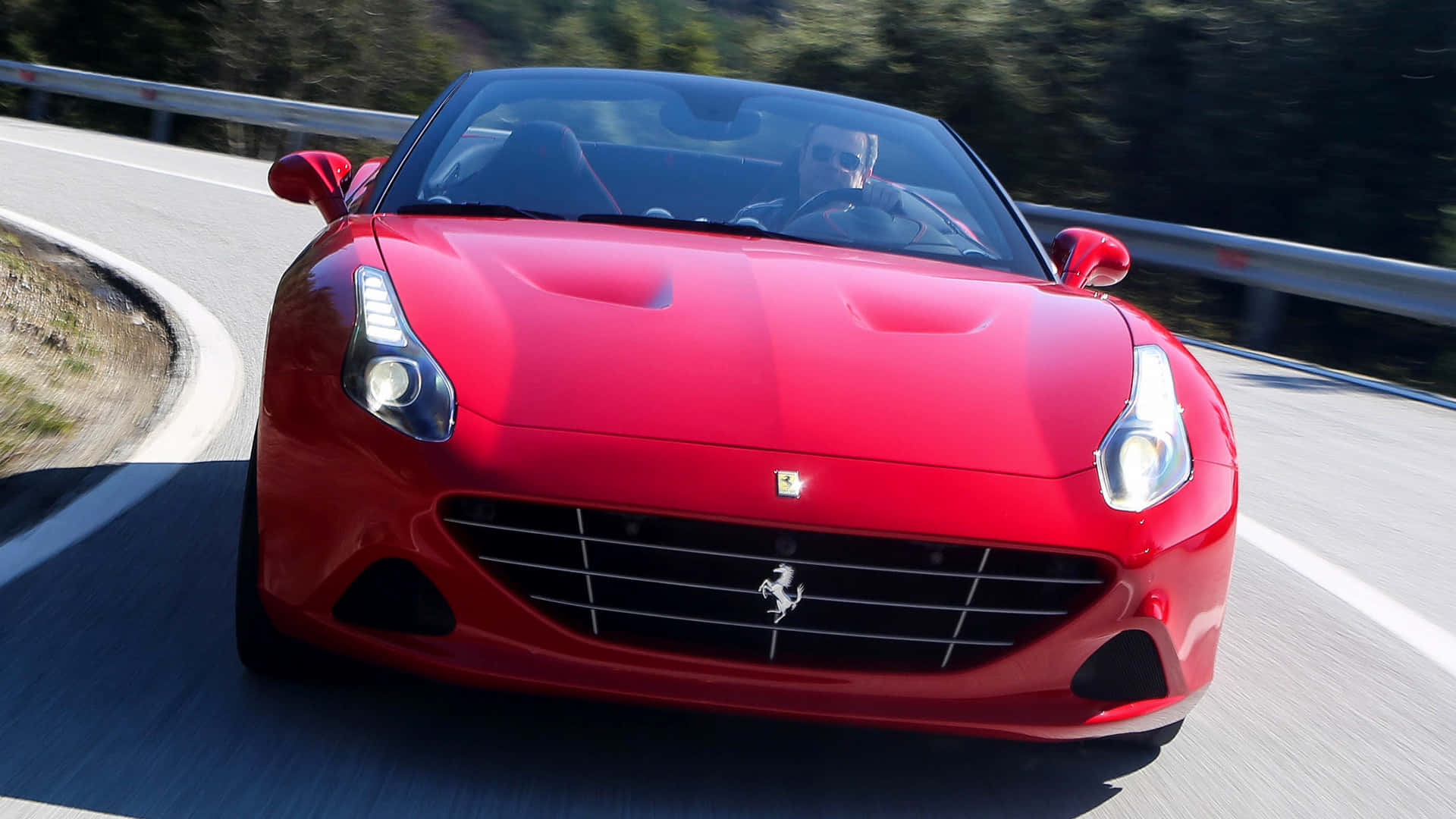 Sleek Ferrari California T in a Scenic Drive Wallpaper