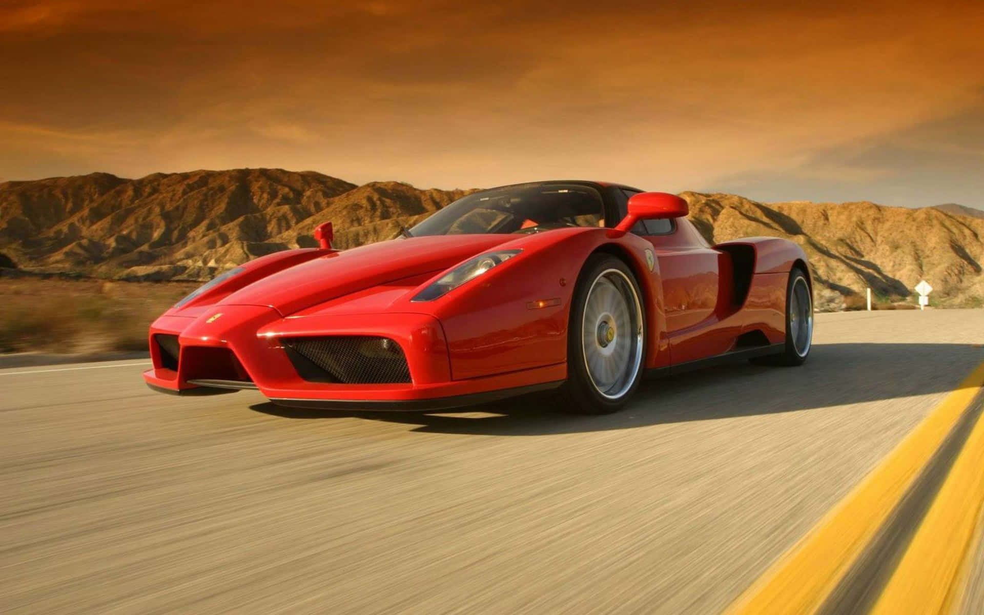 Captivating Ferrari Enzo in a Vibrant Landscape Wallpaper