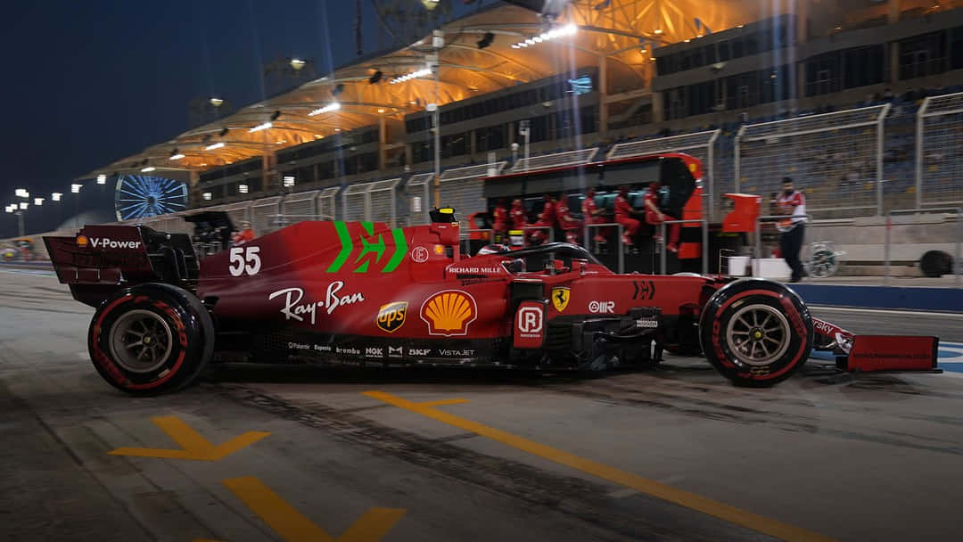 A red Ferrari F1 racecar speeding on a track. Wallpaper
