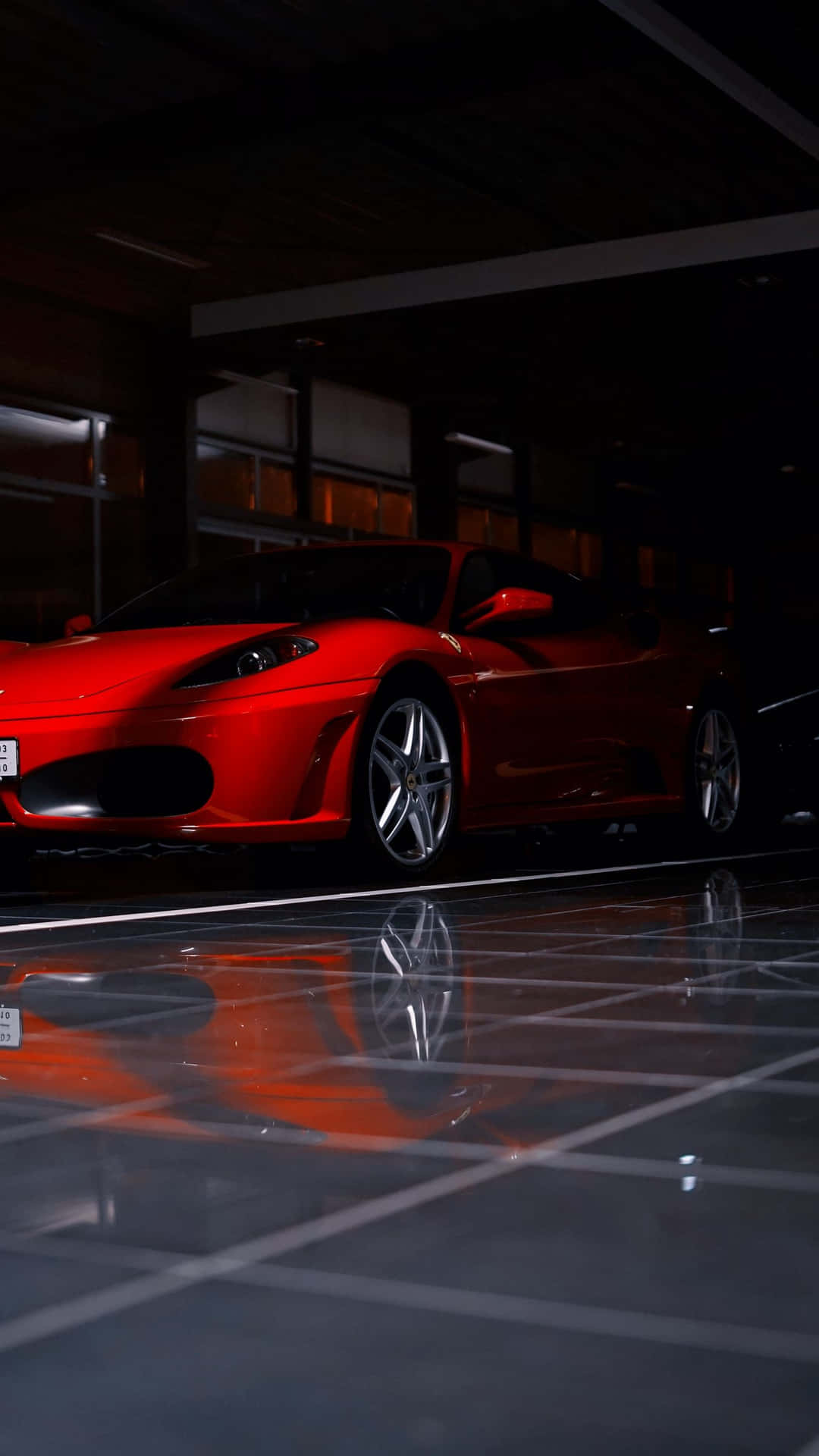 A stunning red Ferrari F430 showcasing its sleek design and powerful presence Wallpaper