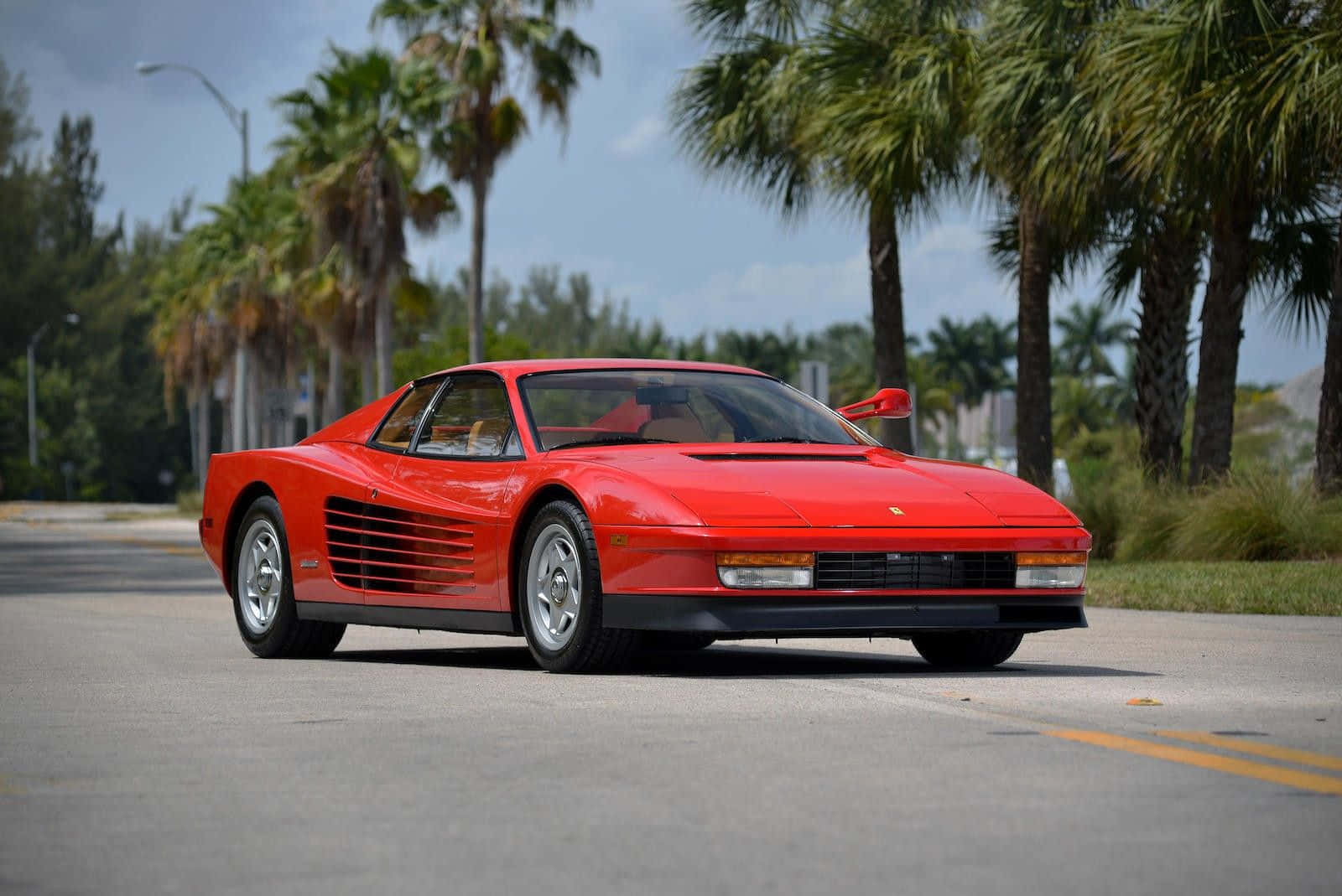 Sleek Red Ferrari Testarossa on the Open Road Wallpaper