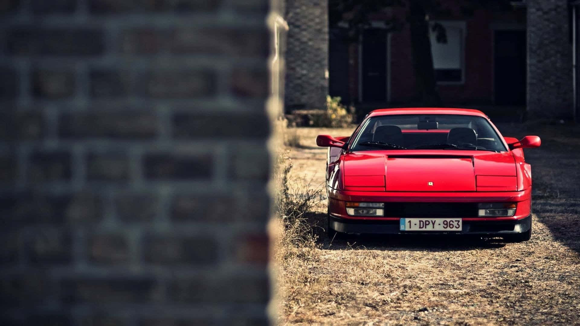 Sleek Red Ferrari Testarossa on the Road Wallpaper