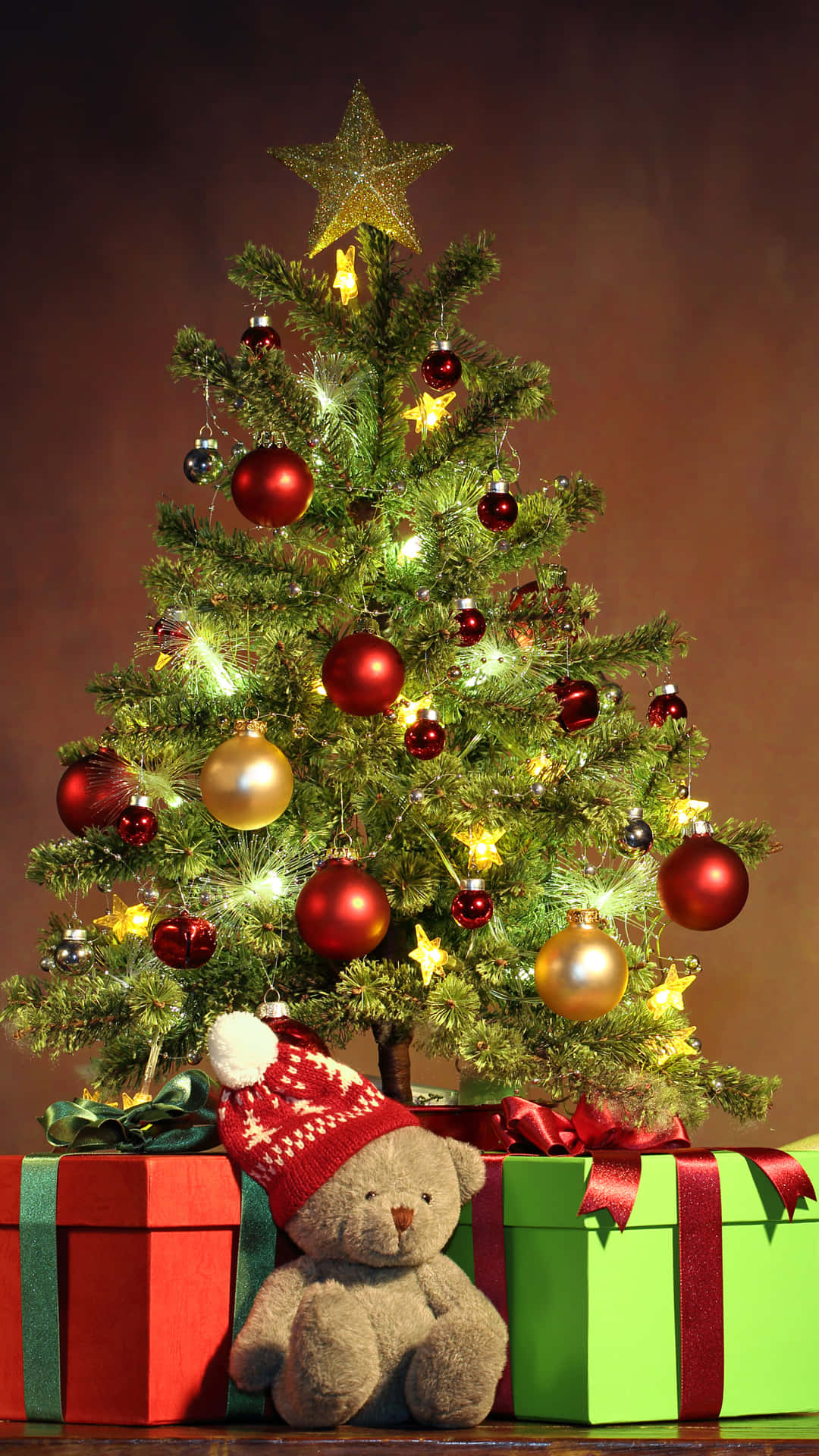 Festive Christmas Tree With Giftsand Teddy Bear.jpg Wallpaper
