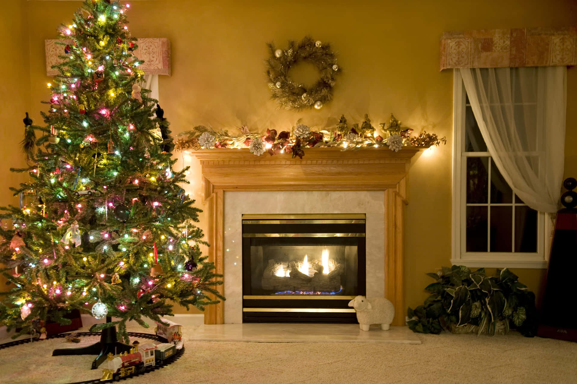 Festive Christmas Treeand Fireplace Decor Wallpaper