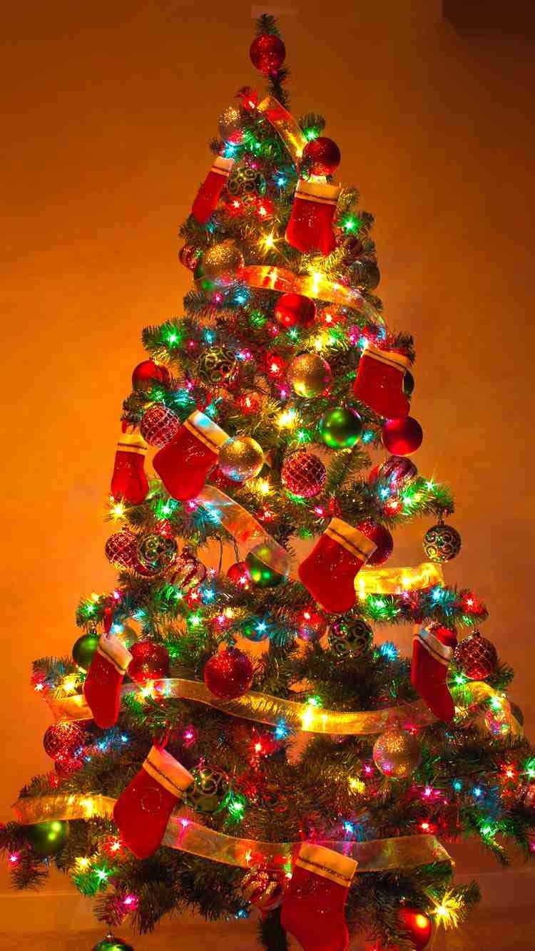 Festive Christmas Treewith Lightsand Decorations Wallpaper