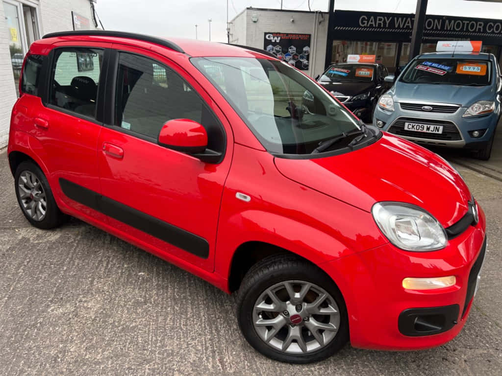 Sleek and Modern Red Fiat Panda on the Road Wallpaper