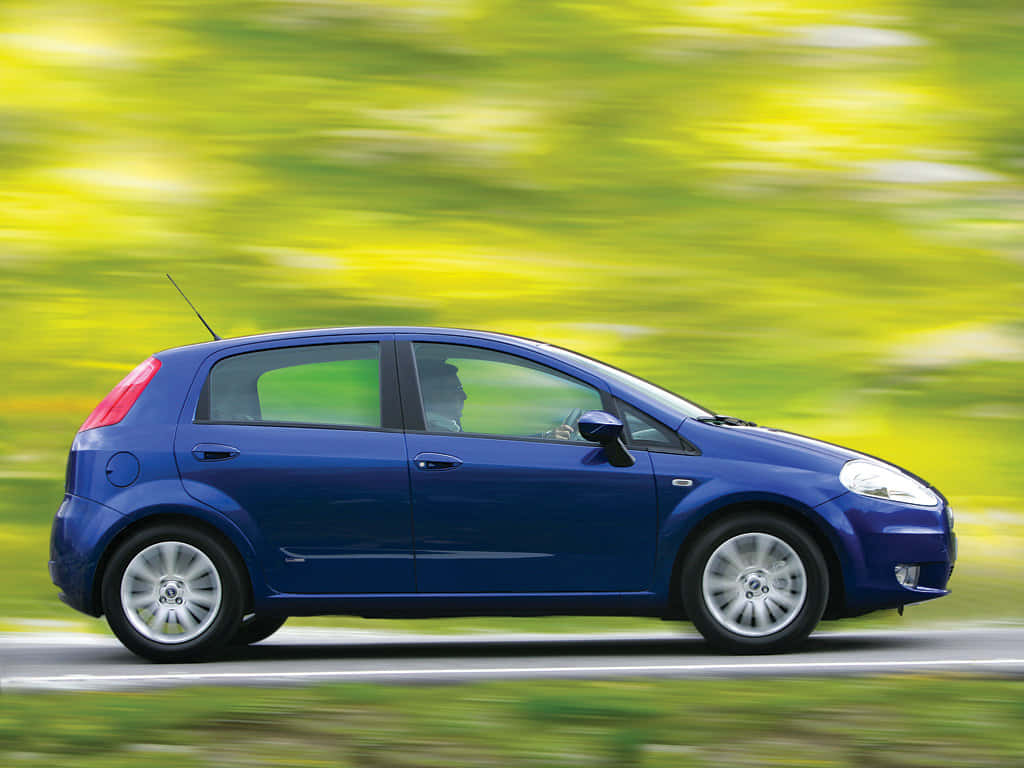 Sleek Fiat Punto Showcased under Rays of Sunlight Wallpaper