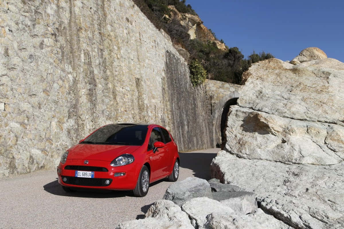 Sporty Fiat Punto in Scenic Landscape Wallpaper