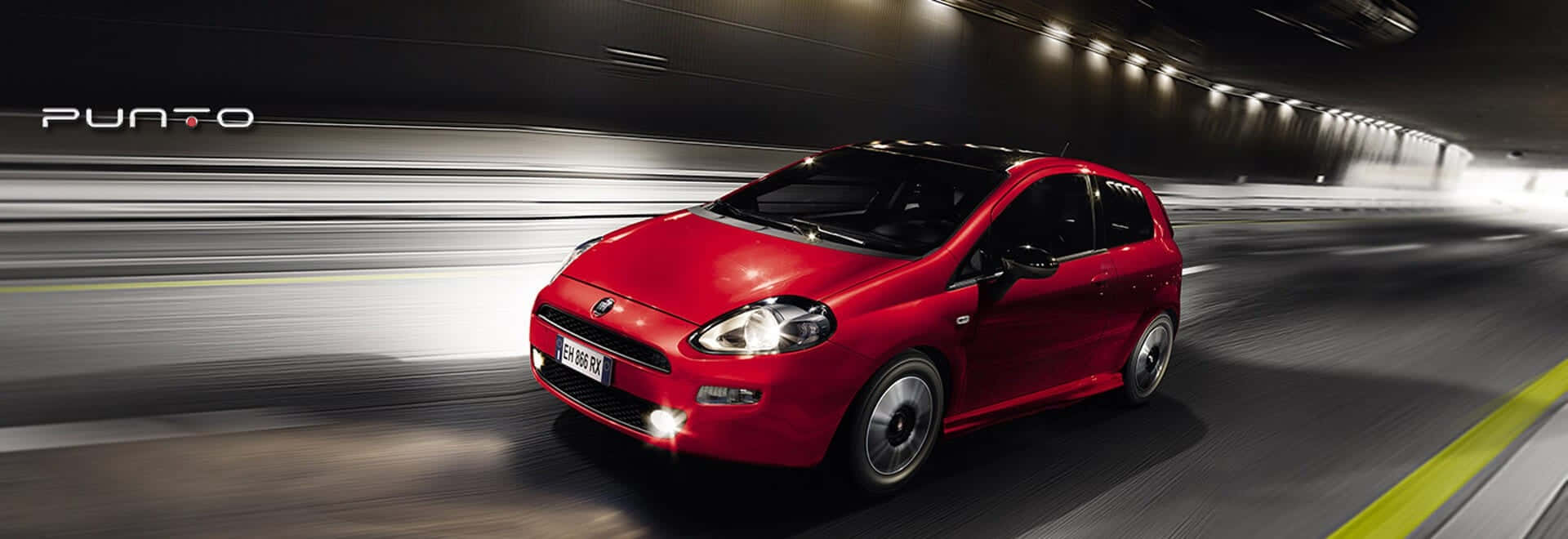 Sleek and Stylish Fiat Punto on the Road Wallpaper