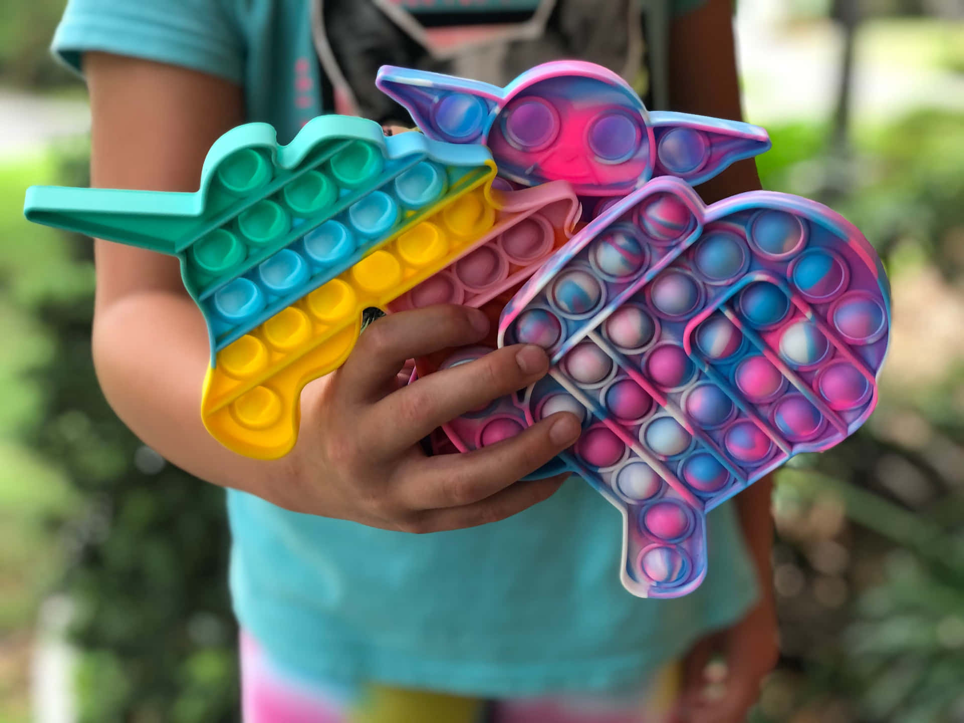 A Girl Holding A Colorful Toy With A Unicorn On It