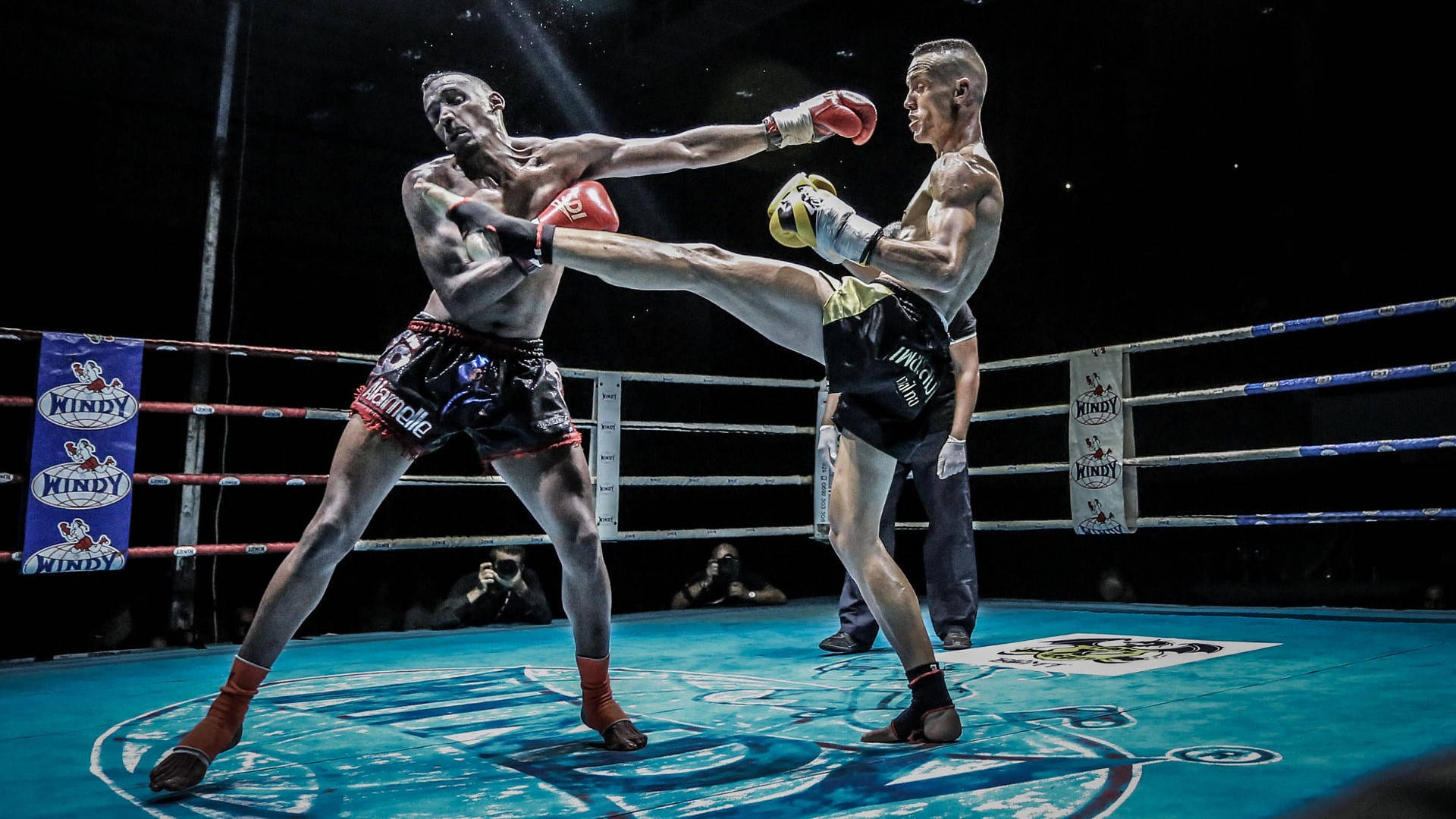 Exciting Moments Captured During an Intense Kickboxing Match Wallpaper