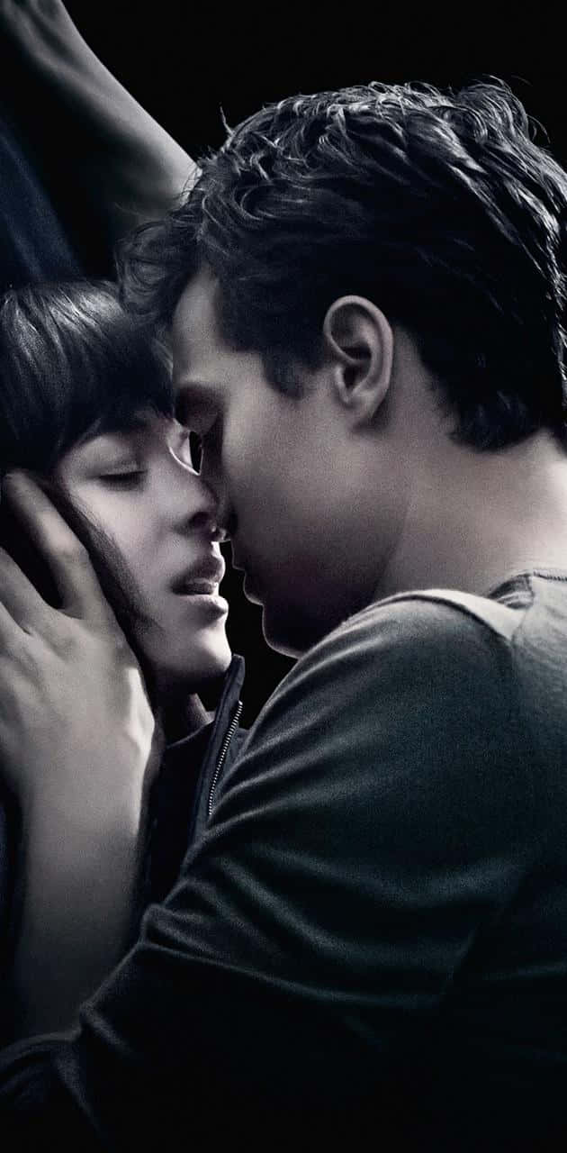 Jamie Dornan og Dakota Johnson som Christian Grey og Anastasia Steele i den romantiske-drama 50 Shades Of Grey. Wallpaper