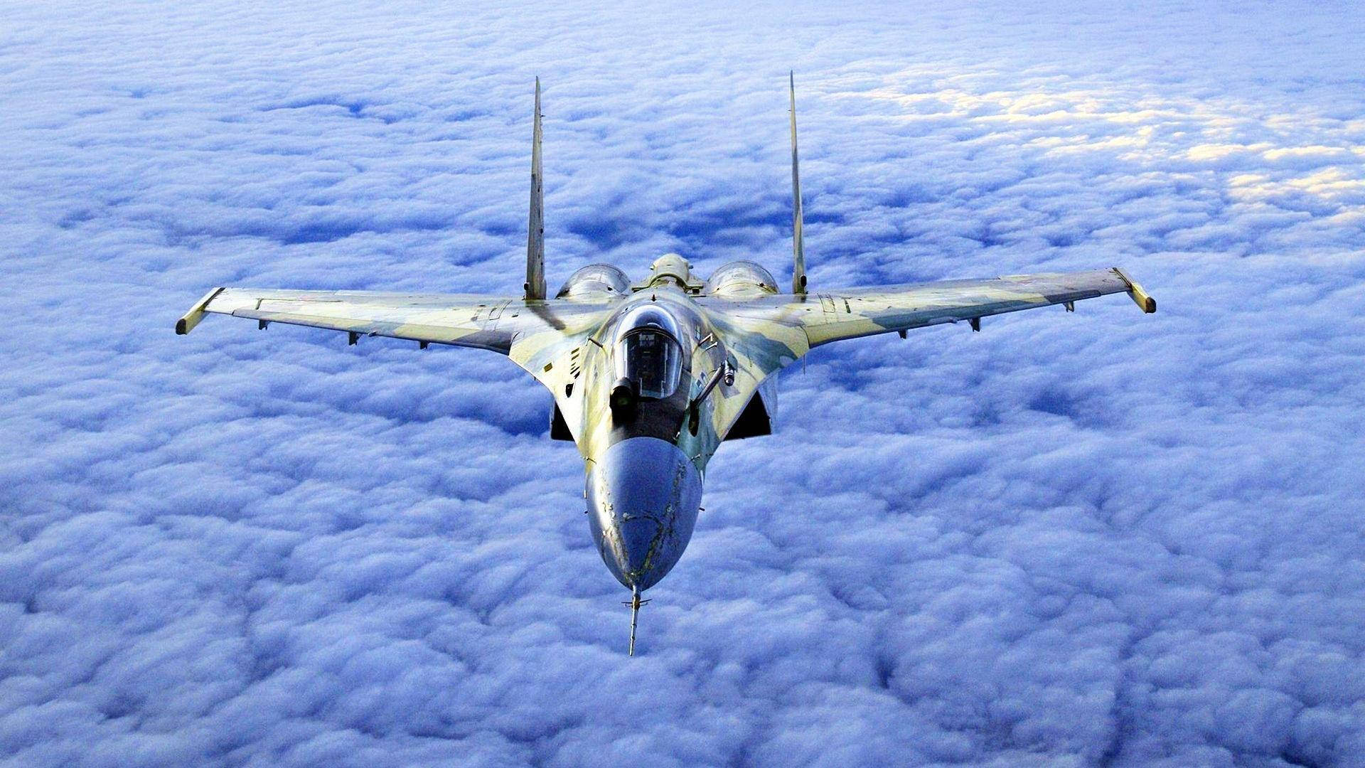 Fighter Jet Over A Cloud Cover Wallpaper