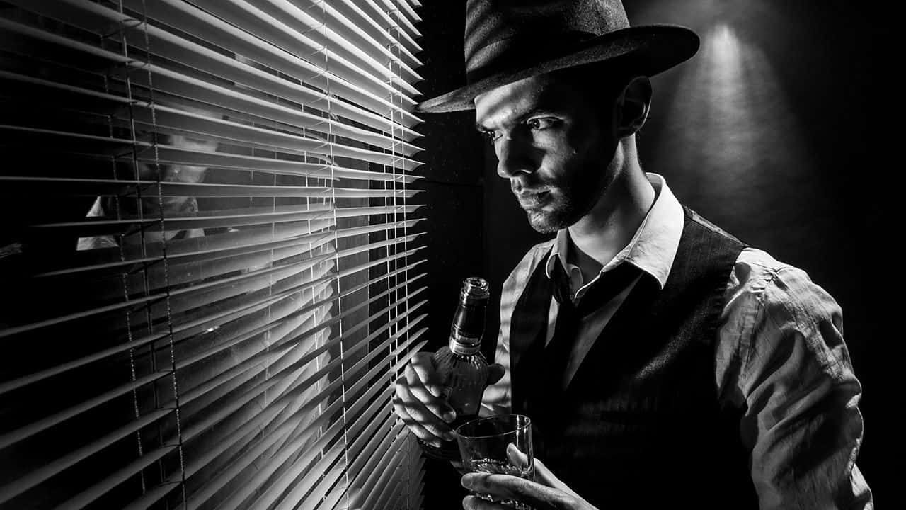 A Mysterious and Shadowy Film Noir Scene Wallpaper