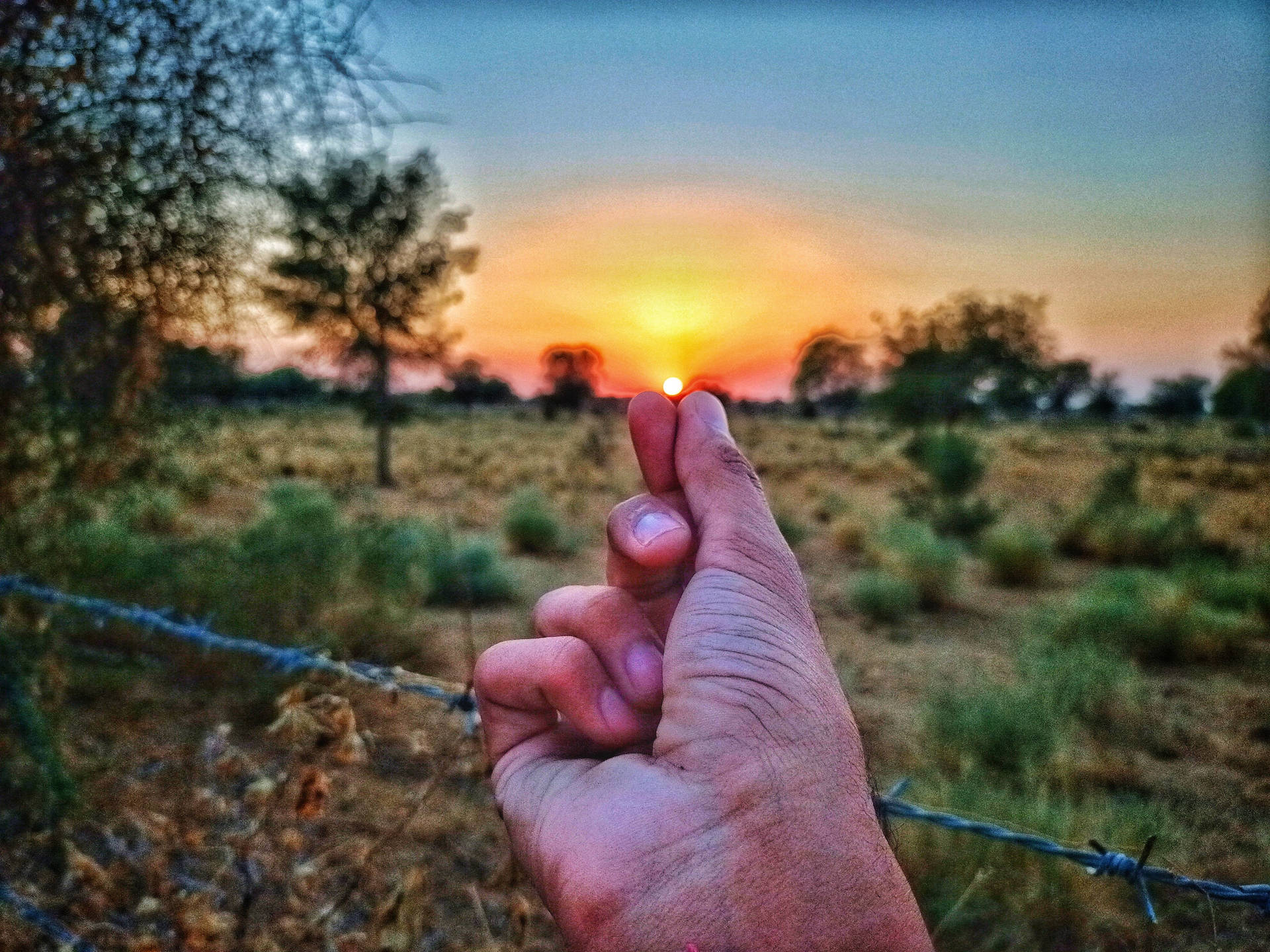 Finger Heart Pointing To A Sunset Wallpaper