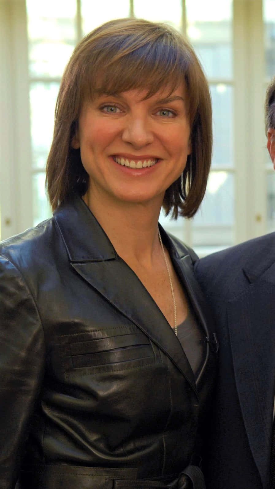 Fiona Bruce striking a pose against a blue background Wallpaper