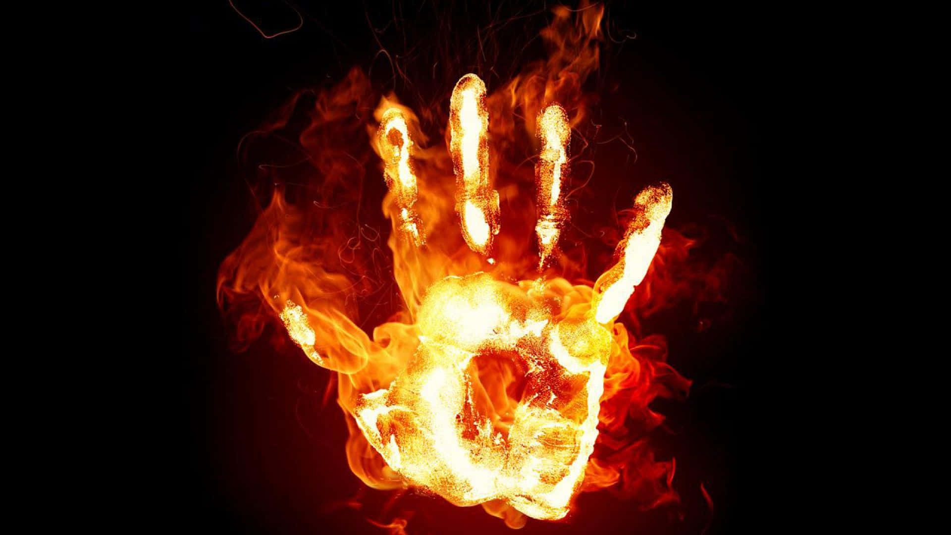 a hand with flames on a black background