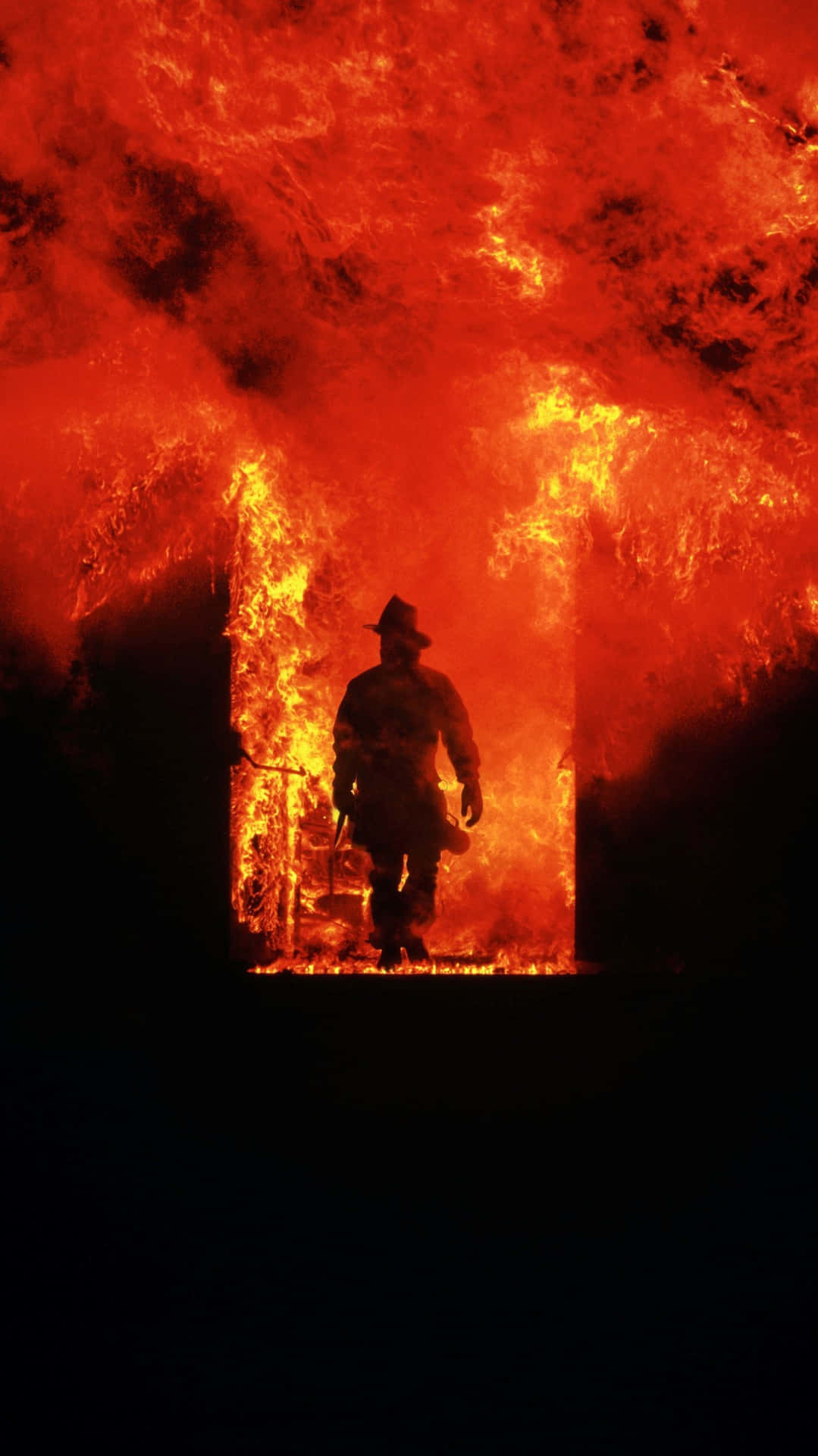 Fire Department Officer In A Flaming Building Wallpaper