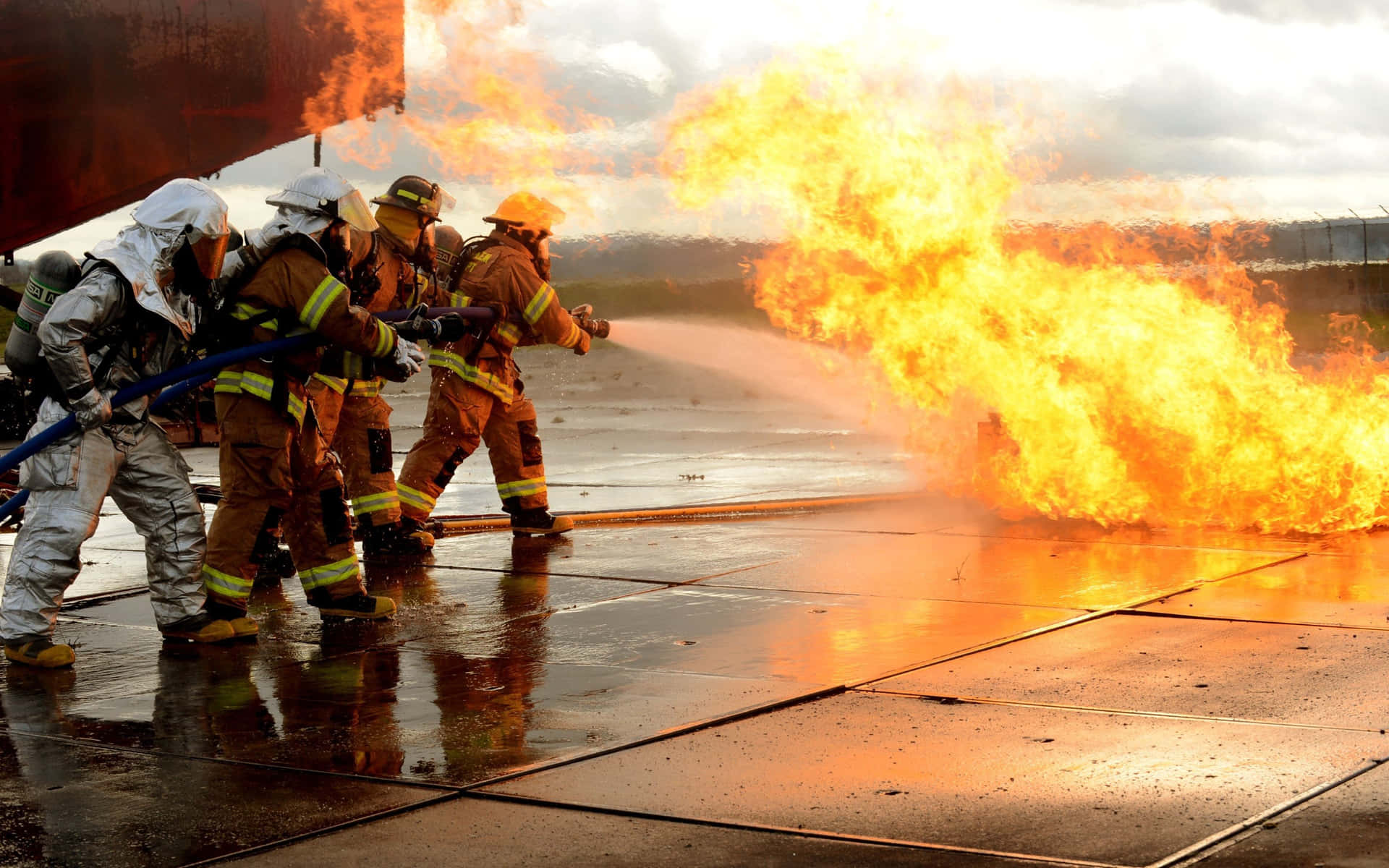 A Group Of Firefighters Are Battling A Fire Wallpaper
