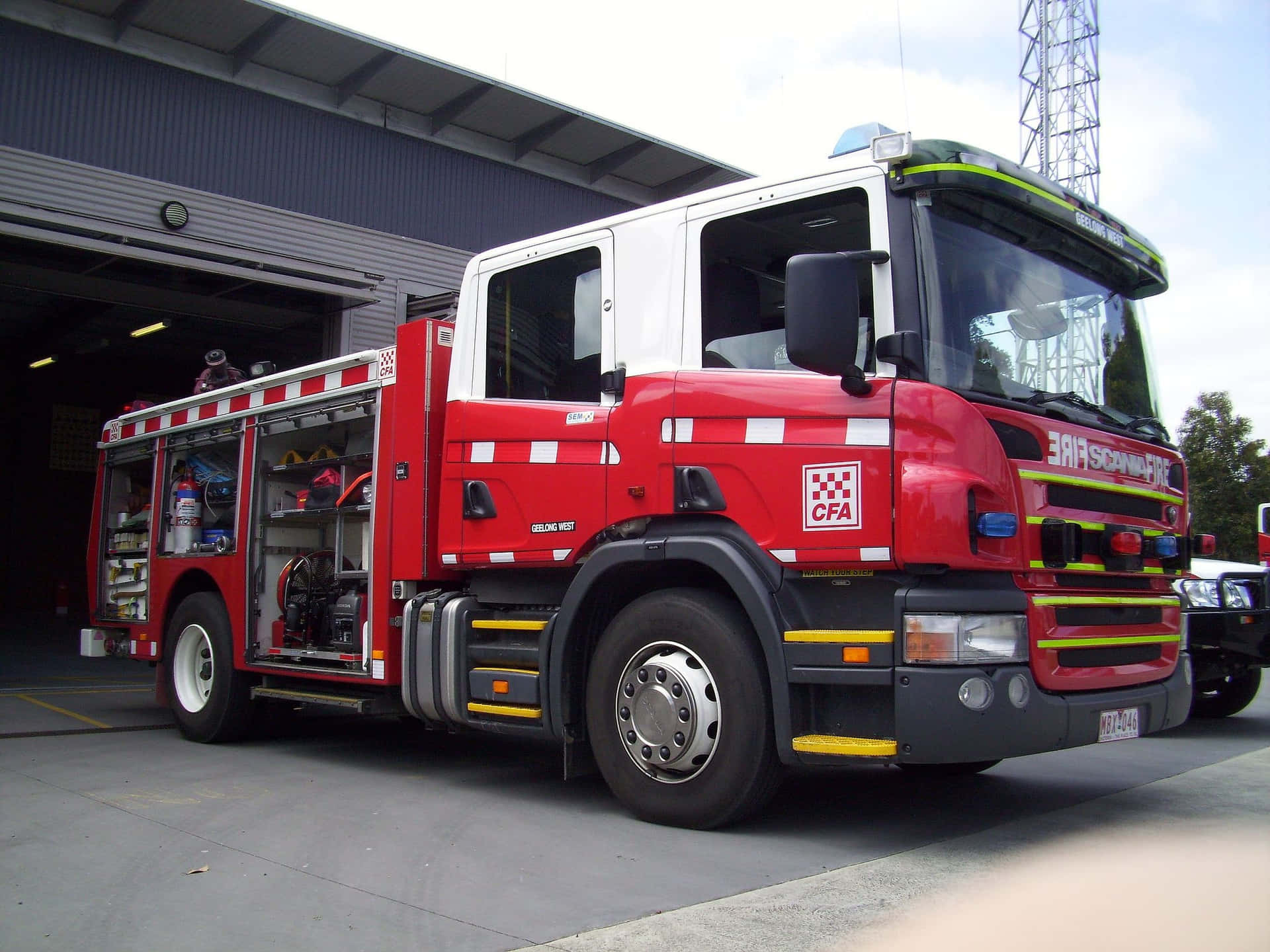 A Fire Truck Parked In Front Of A Building Wallpaper