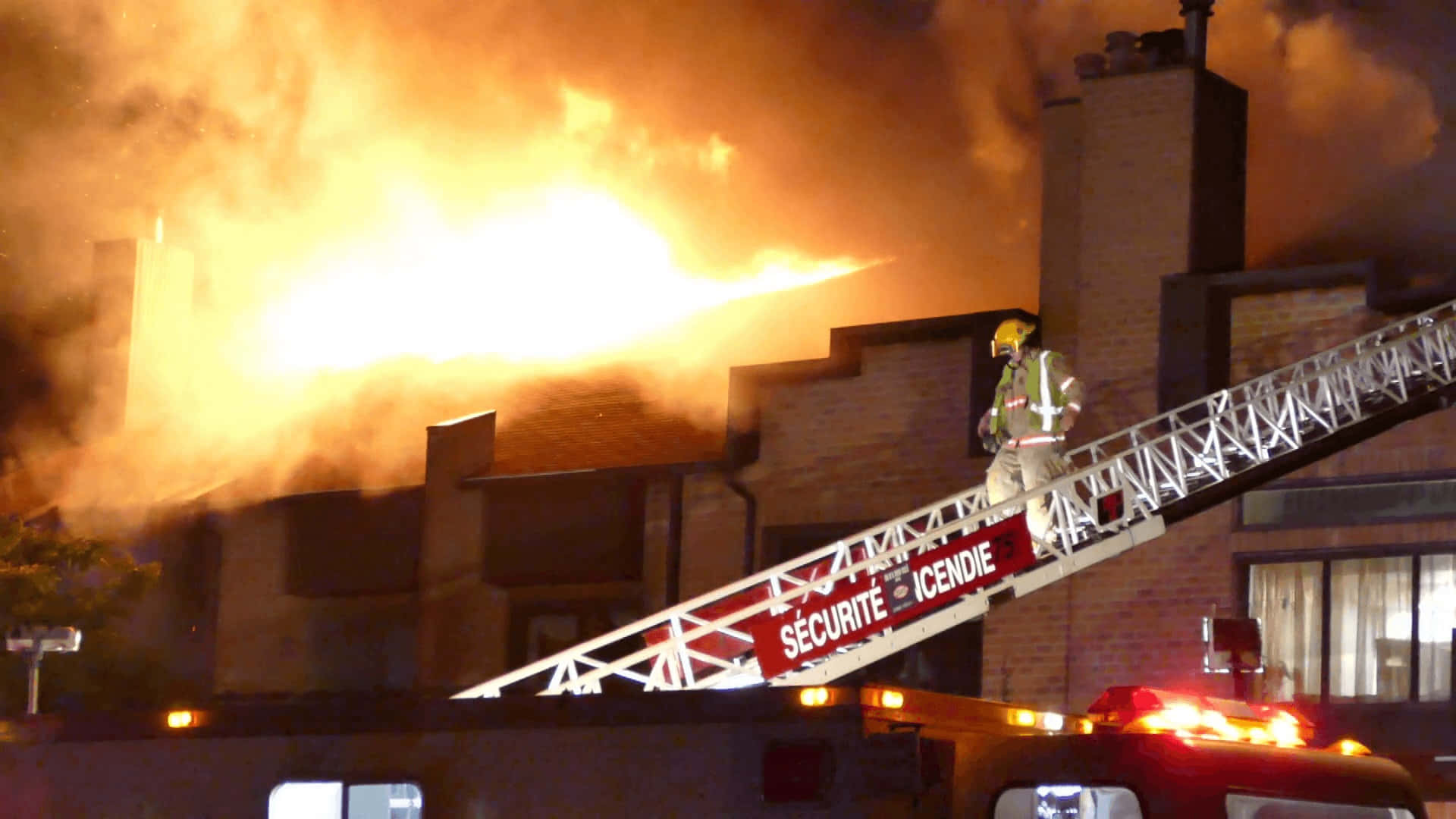 A firefighter bravely battles a burning building.